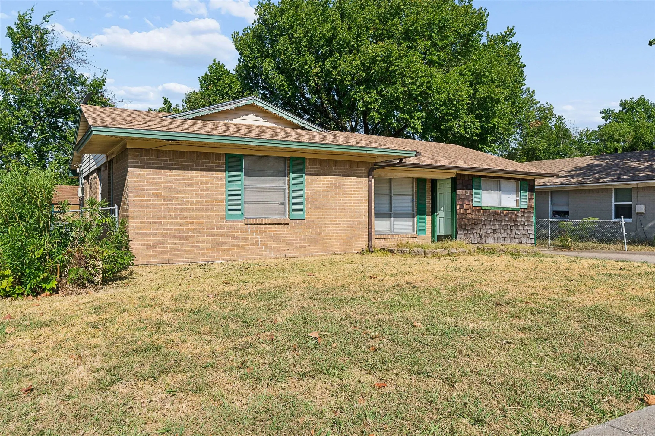 Brick exterior with green window shutters