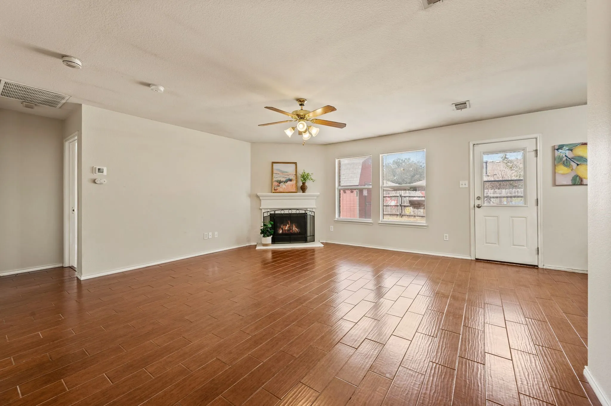 Living room with wood look tile and natural light.