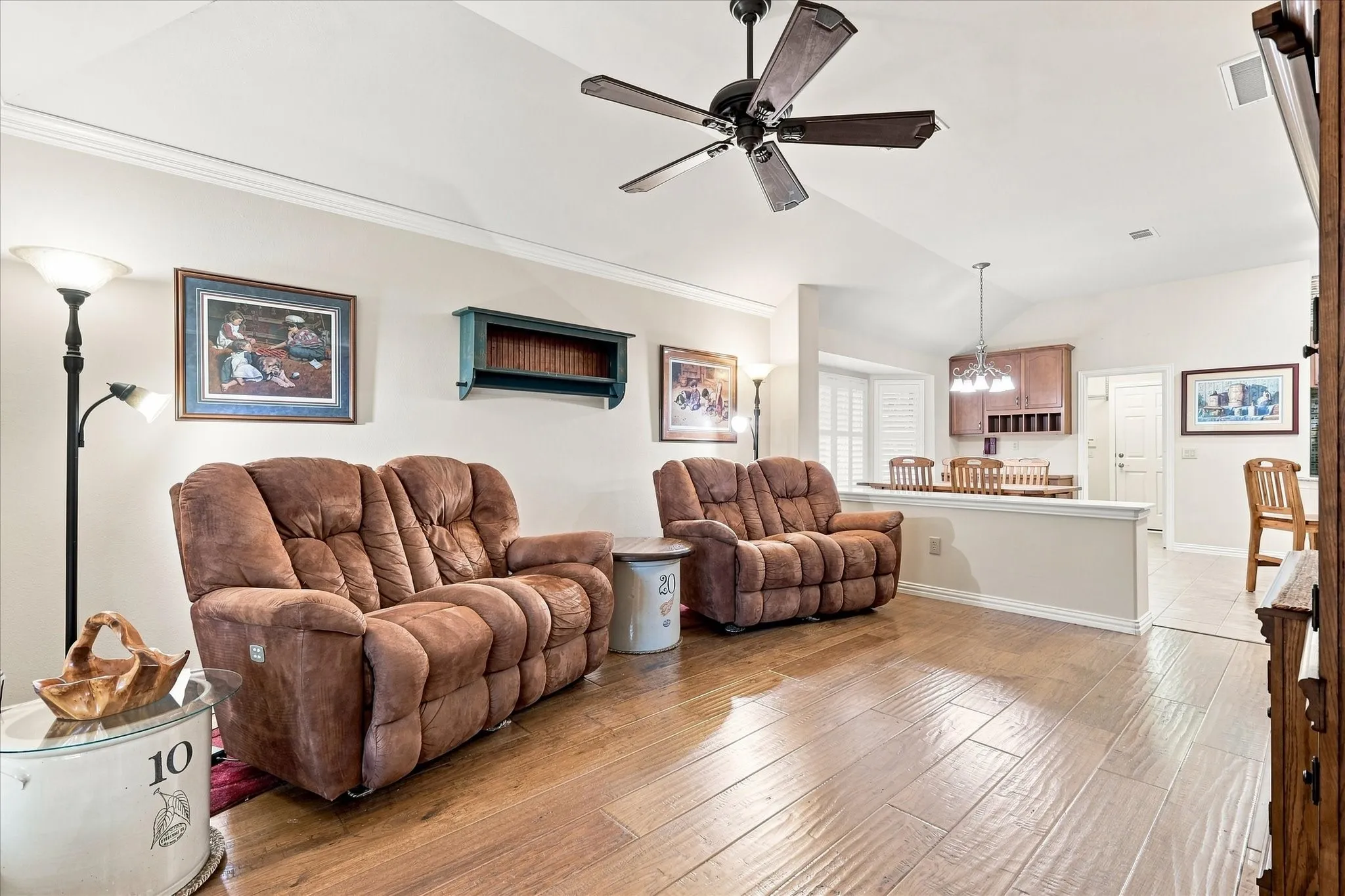 Wood-finish flooring throughout, vaulted ceiling, crown molding, ceiling fan