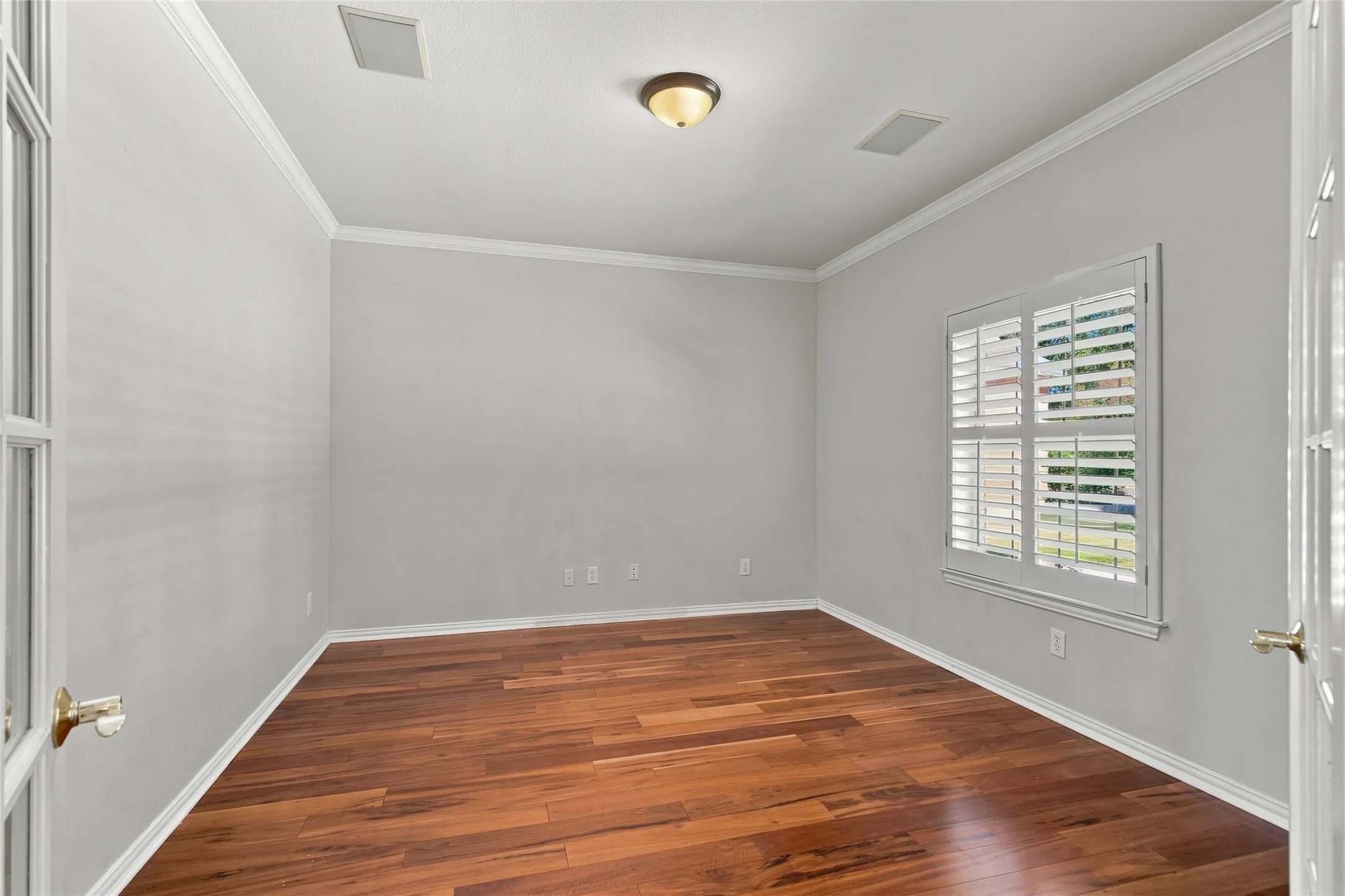 Office or optional bedroom with crown molding, white trim, recessed lighting, and a flush mount light fixture.