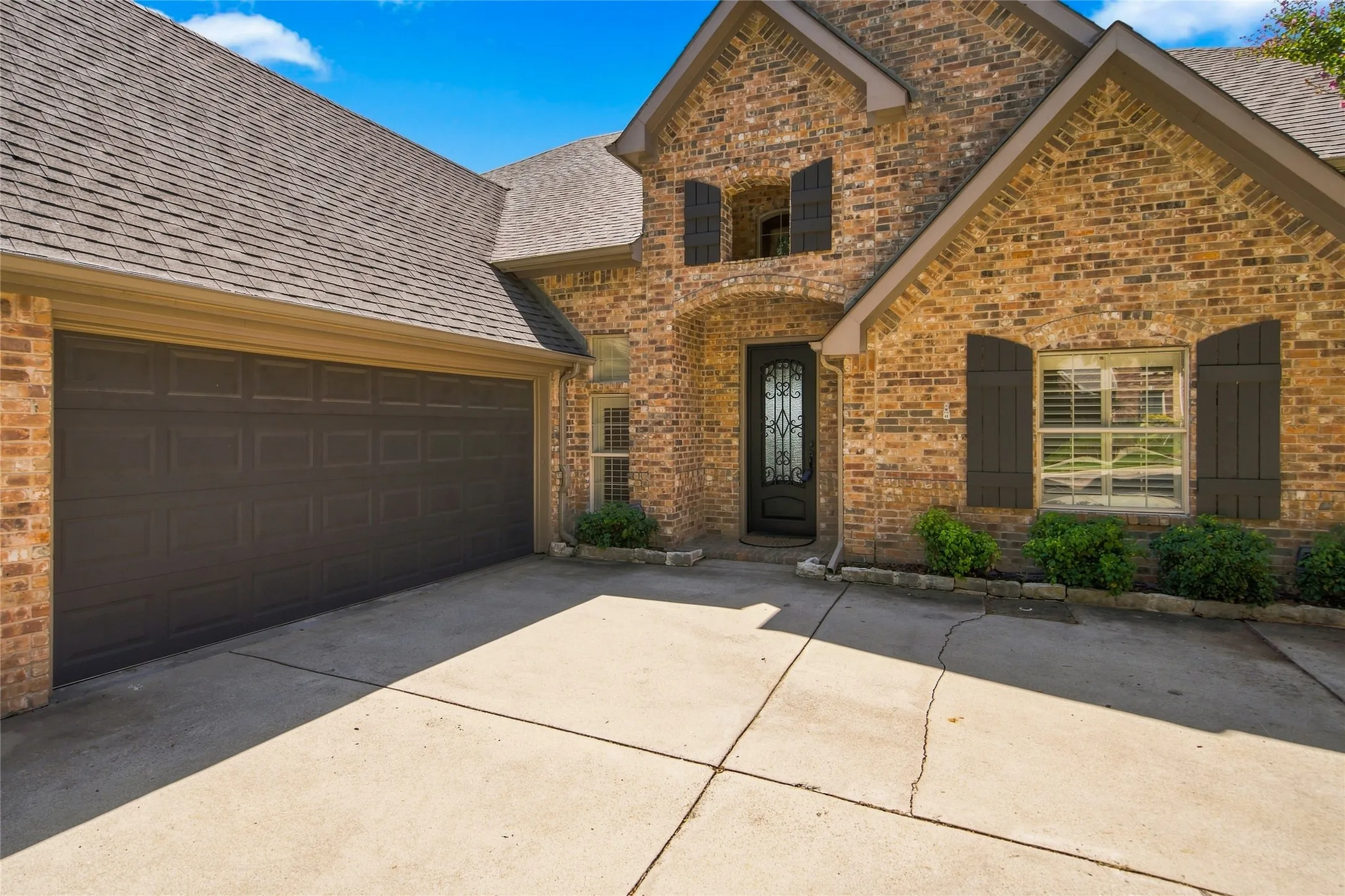 Front Entry with arched entryway and a decorative glass and metal front door.