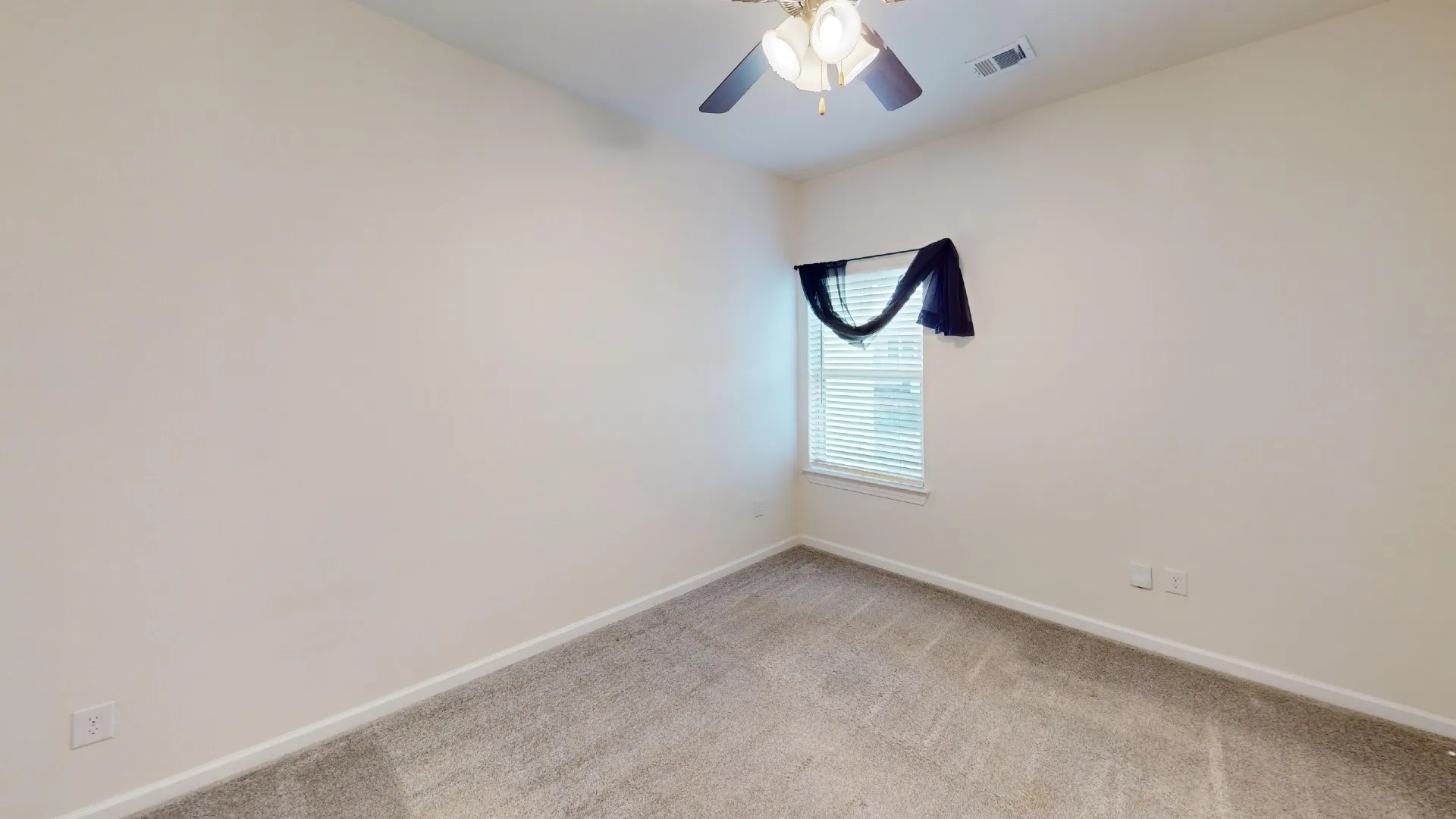 Neutral-toned walls, textured carpeting, built-in ceiling fan with lighting, and a window with blinds