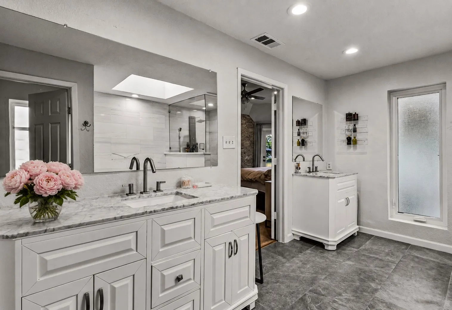 Dual vanity with stone countertops and undermount sinks