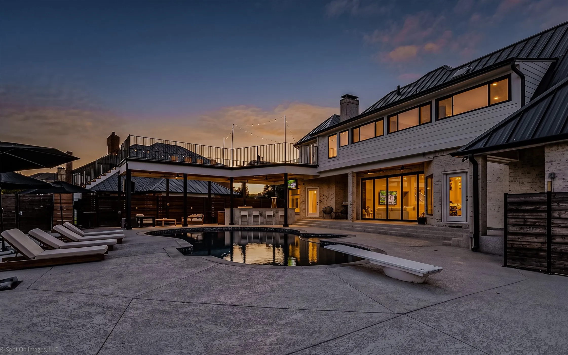 Stamped concrete pool deck with an irregular shape pool