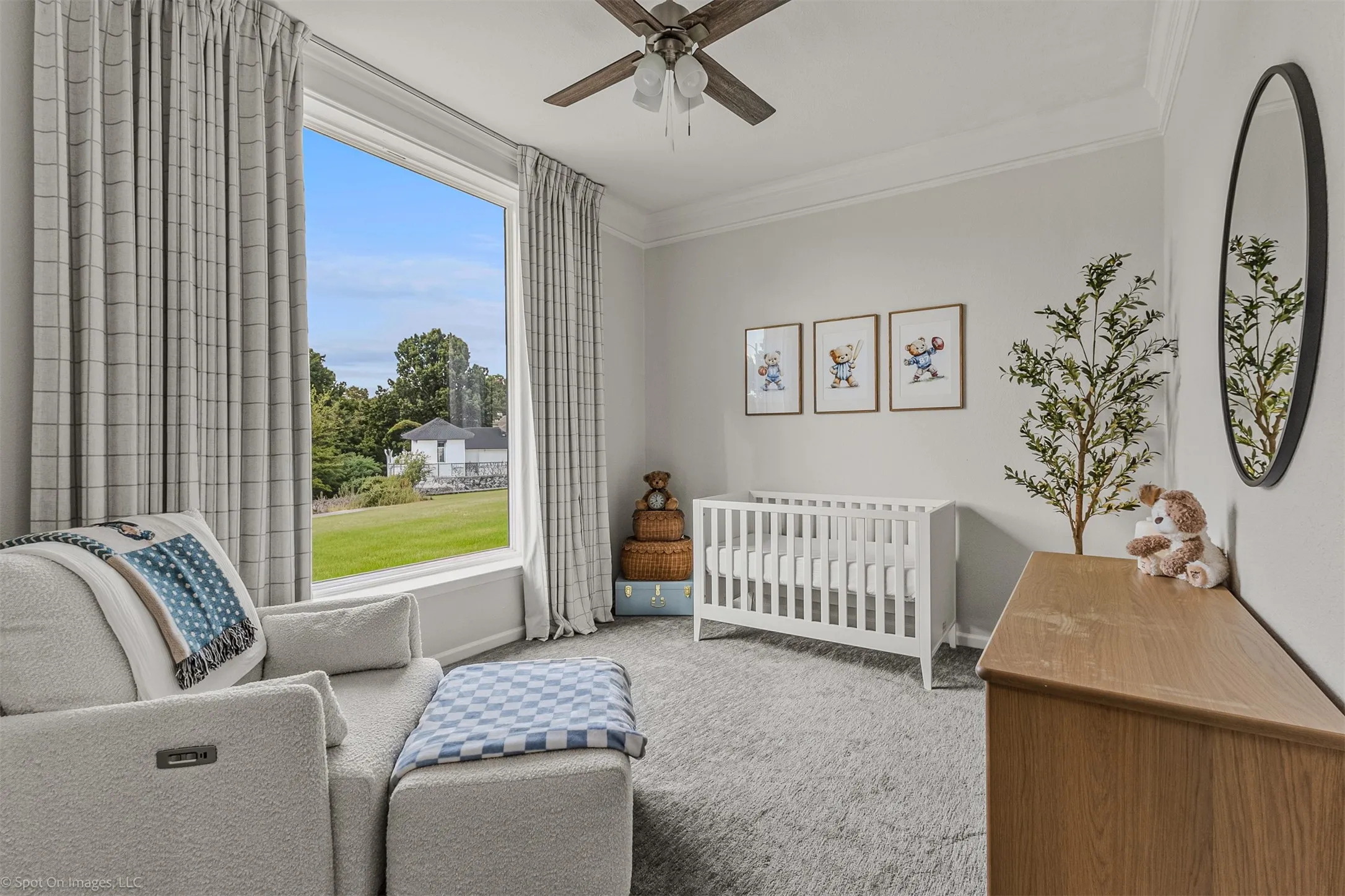 Large window with expansive outdoor scenery, crown molding, ceiling fan, and carpeted flooring