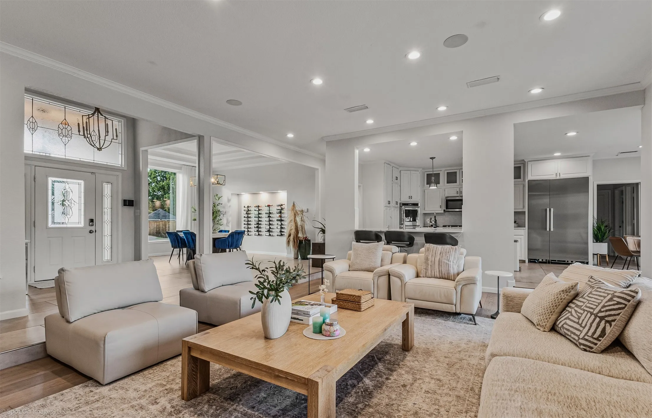 Recessed lighting, wood-finish flooring, and white walls