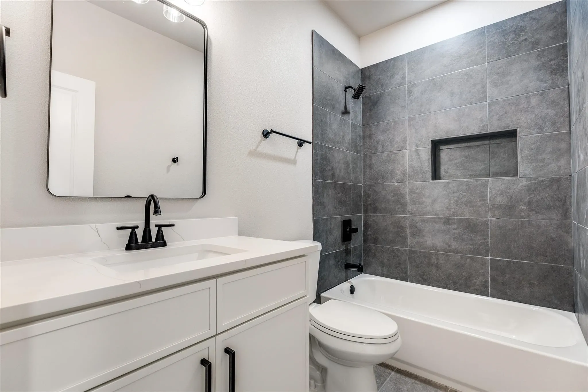 White vanity with a solid surface countertop and undermount sink