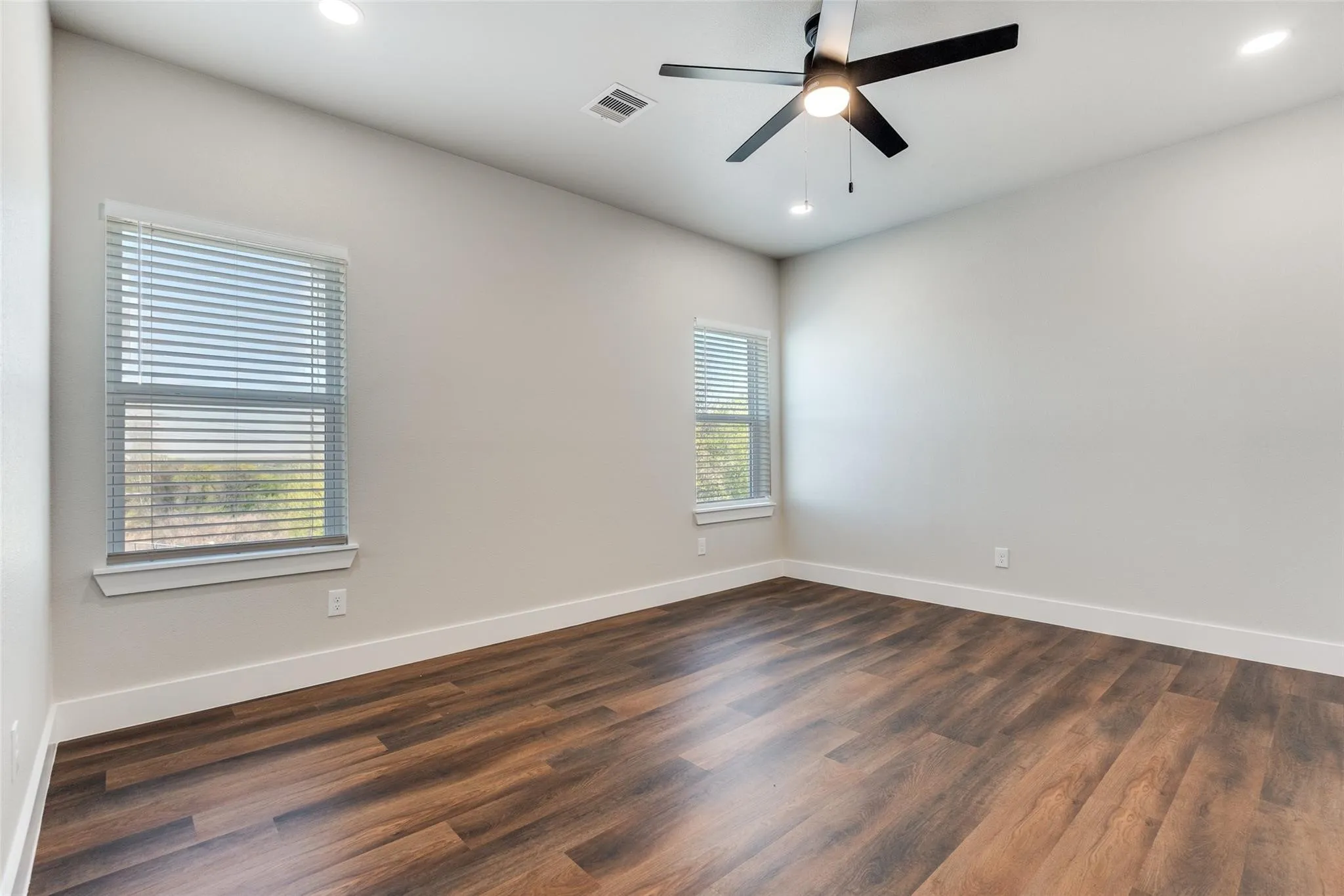 Wood-finish flooring, recessed lighting, and a ceiling fan