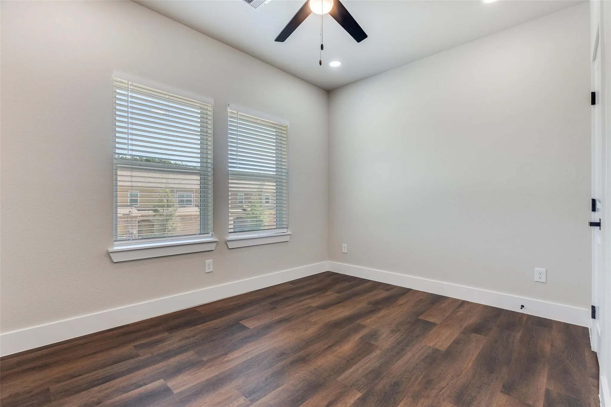 Wood-finish flooring, recessed lighting, and a ceiling fan with integrated lighting