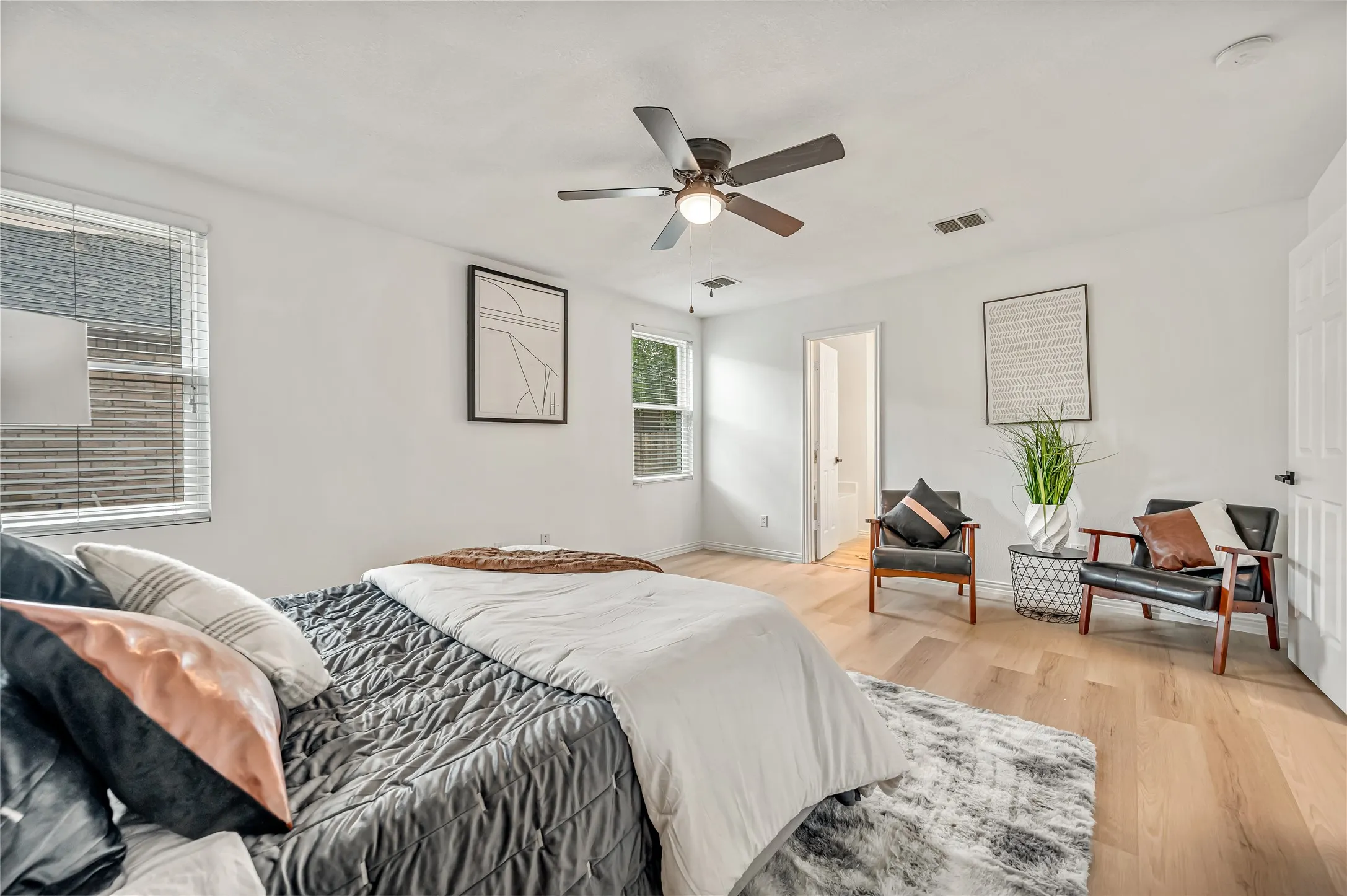 Light wood-finish flooring with white walls