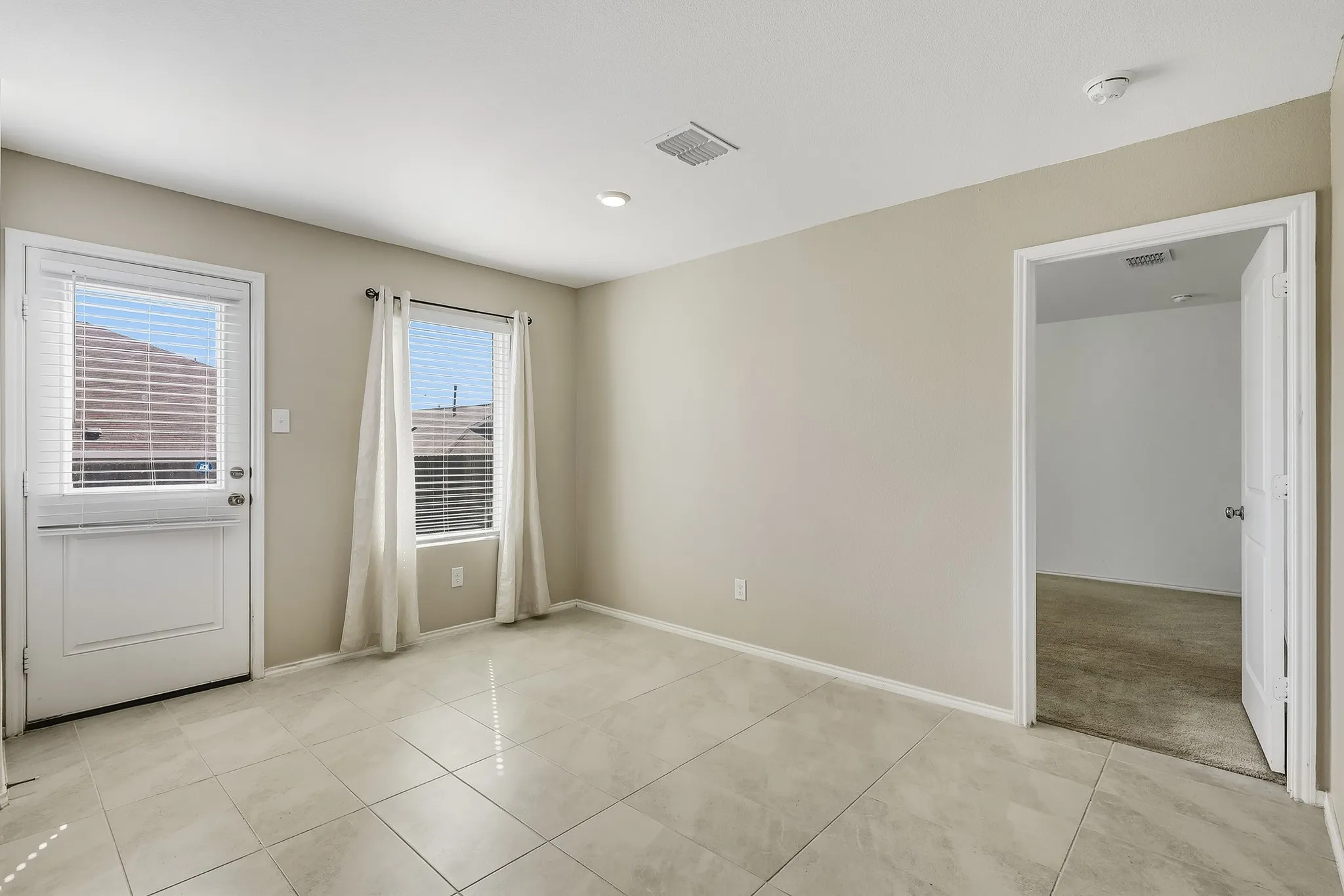 Light-colored tile flooring, window with blinds, recessed lighting, and neutral wall paint