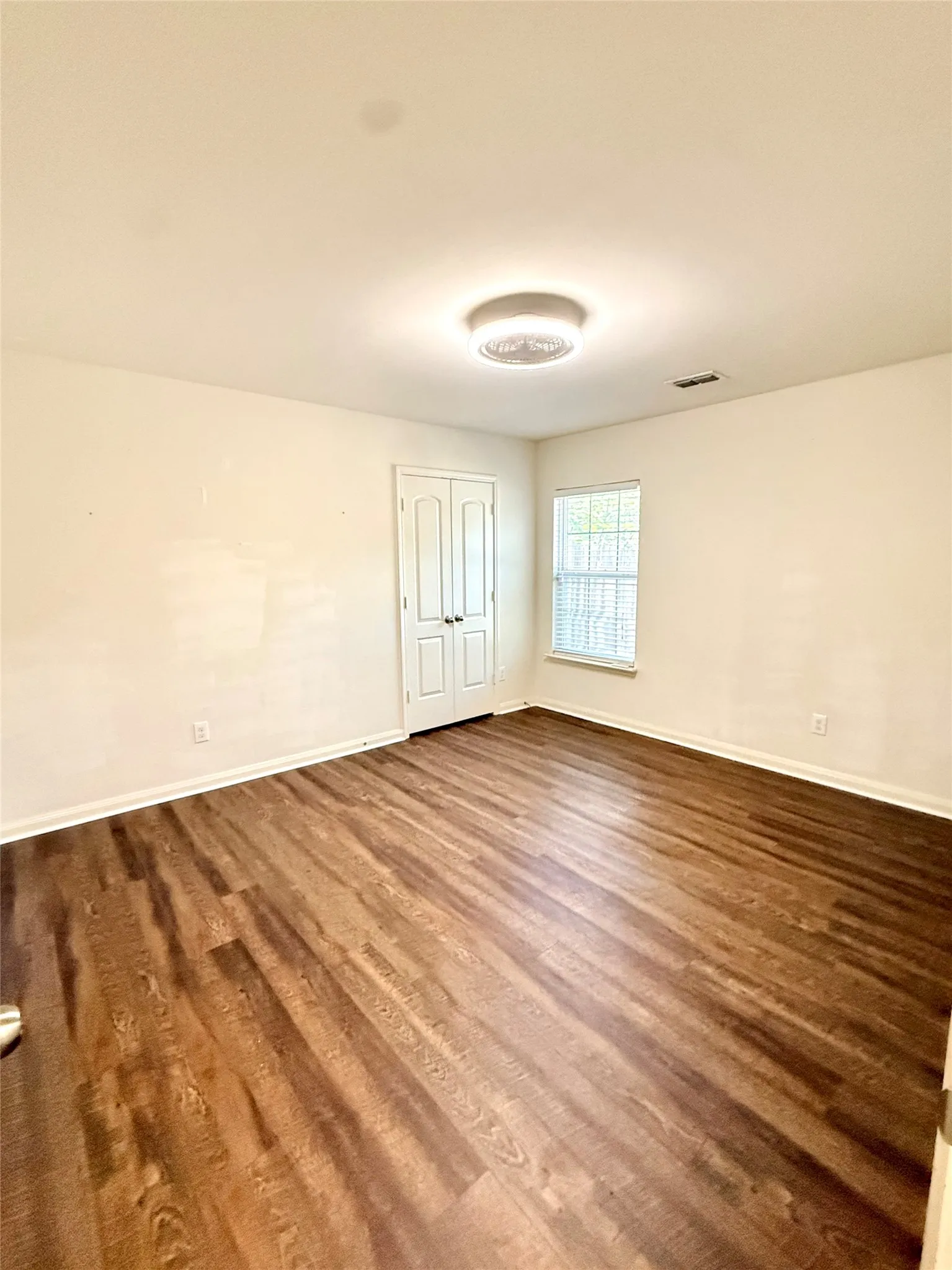 Bedroom 3 Wood-finish flooring, white walls, and a recessed ceiling light