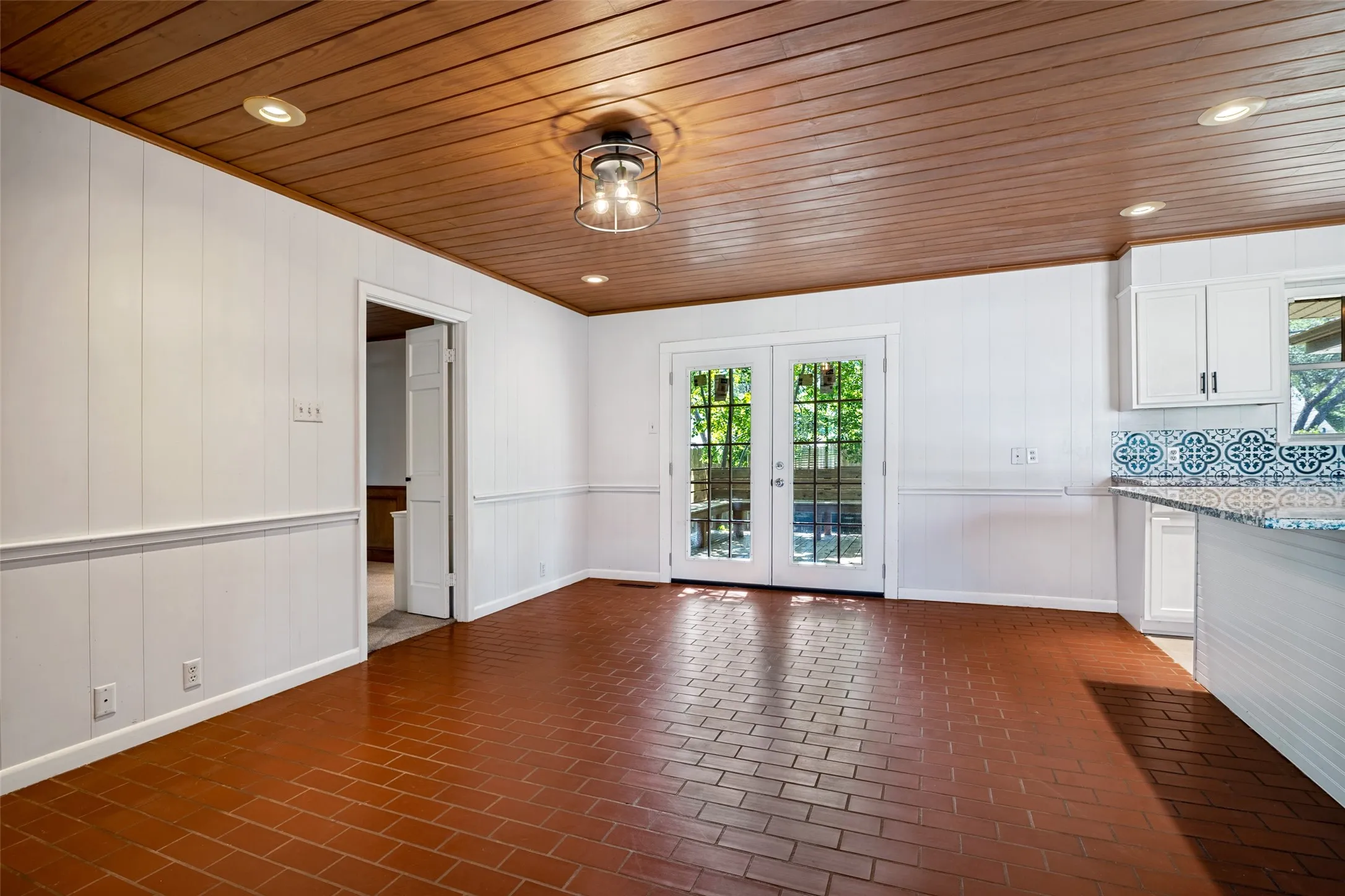 These brick floors are the perfect touch and those patio doors just beckon you to step outside and enjoy the sounds of nature!