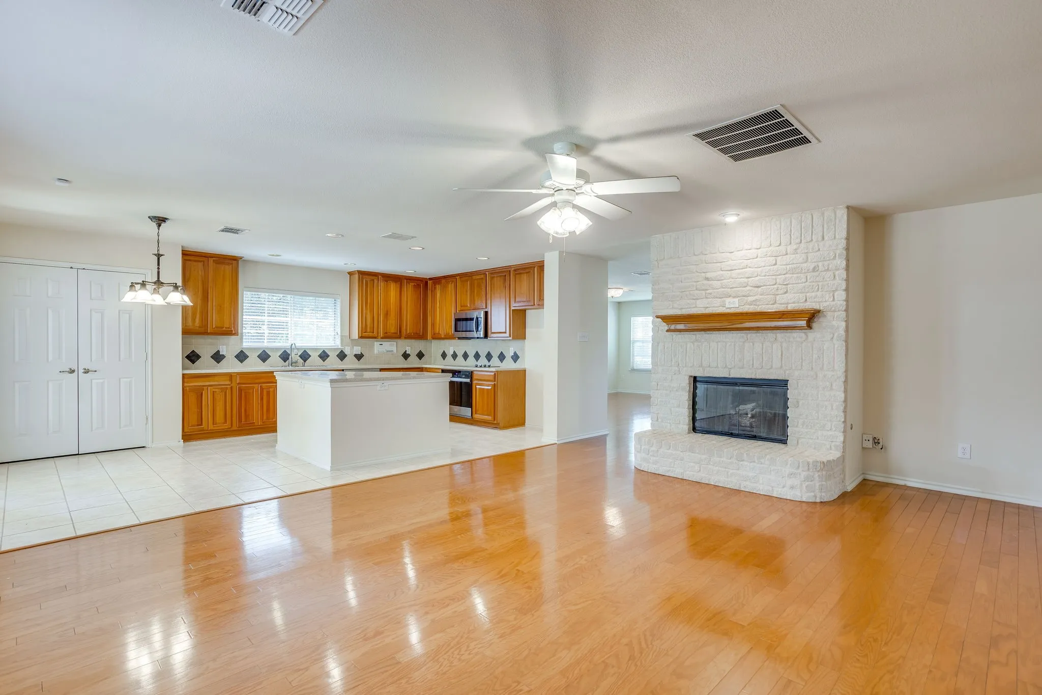 Family Room/Den with fireplace open to the Kitchen.