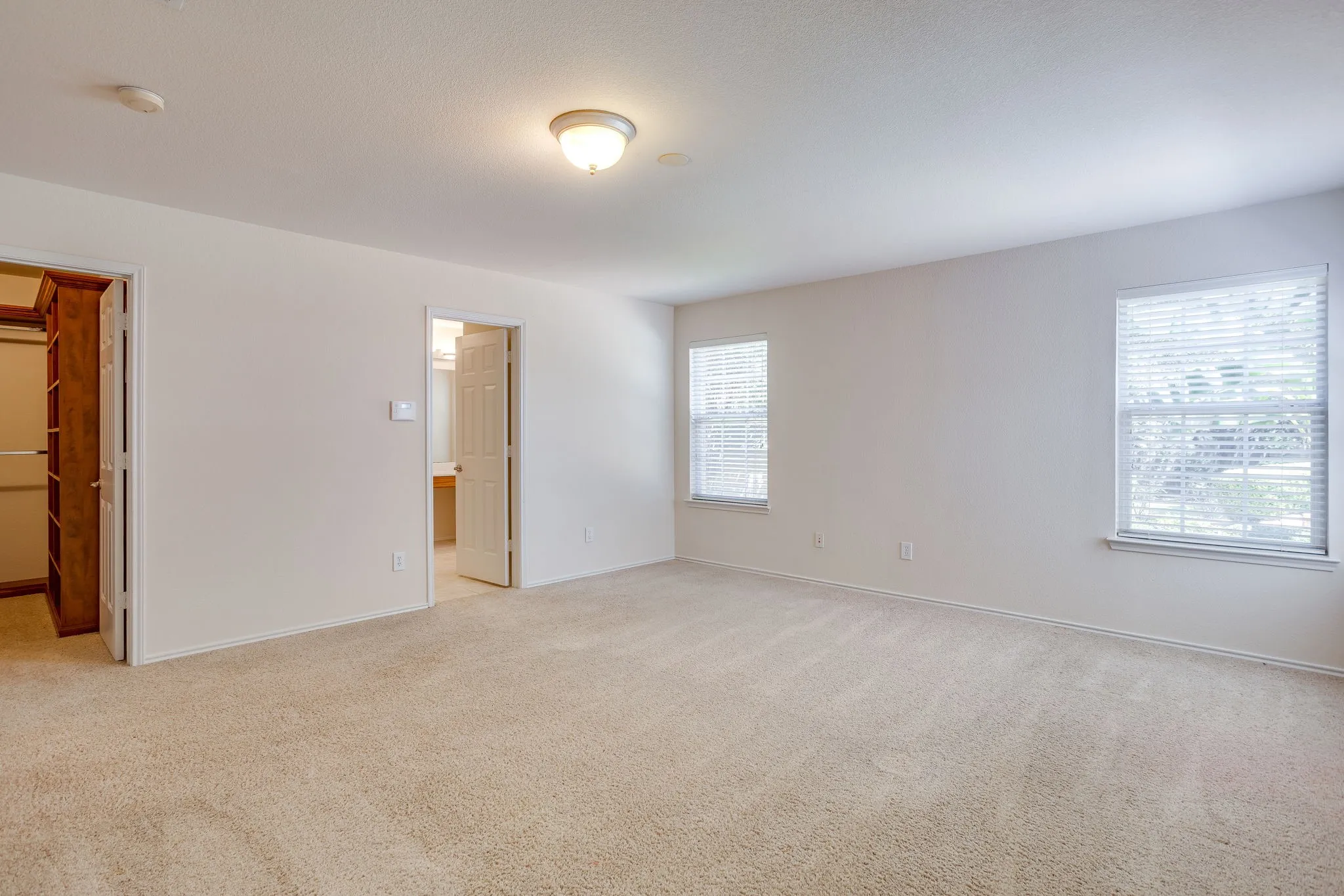 Large Primary Bedroom with a custom closet and ensuite bathroom.