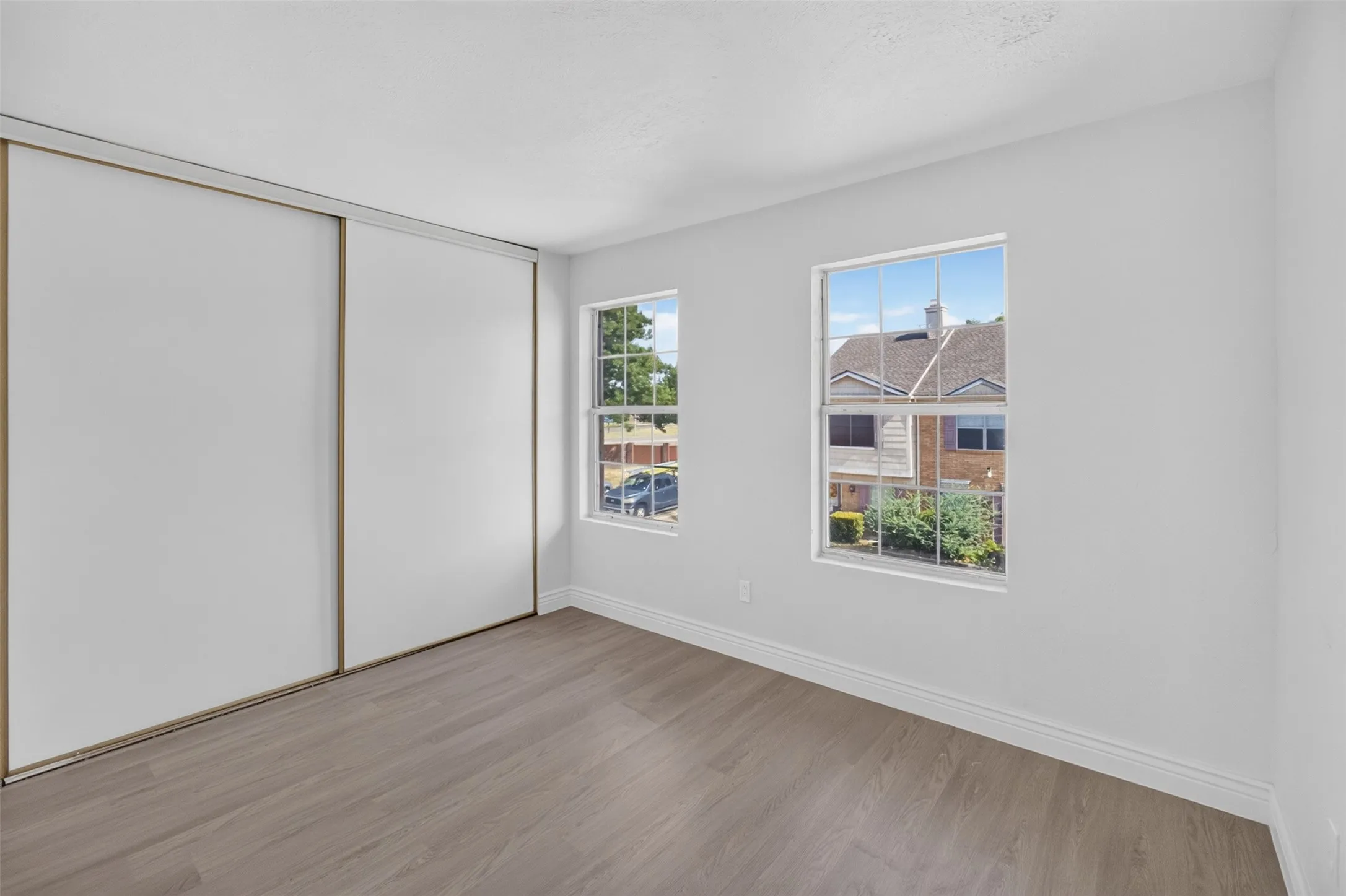 Wood-finish flooring with white walls and trim