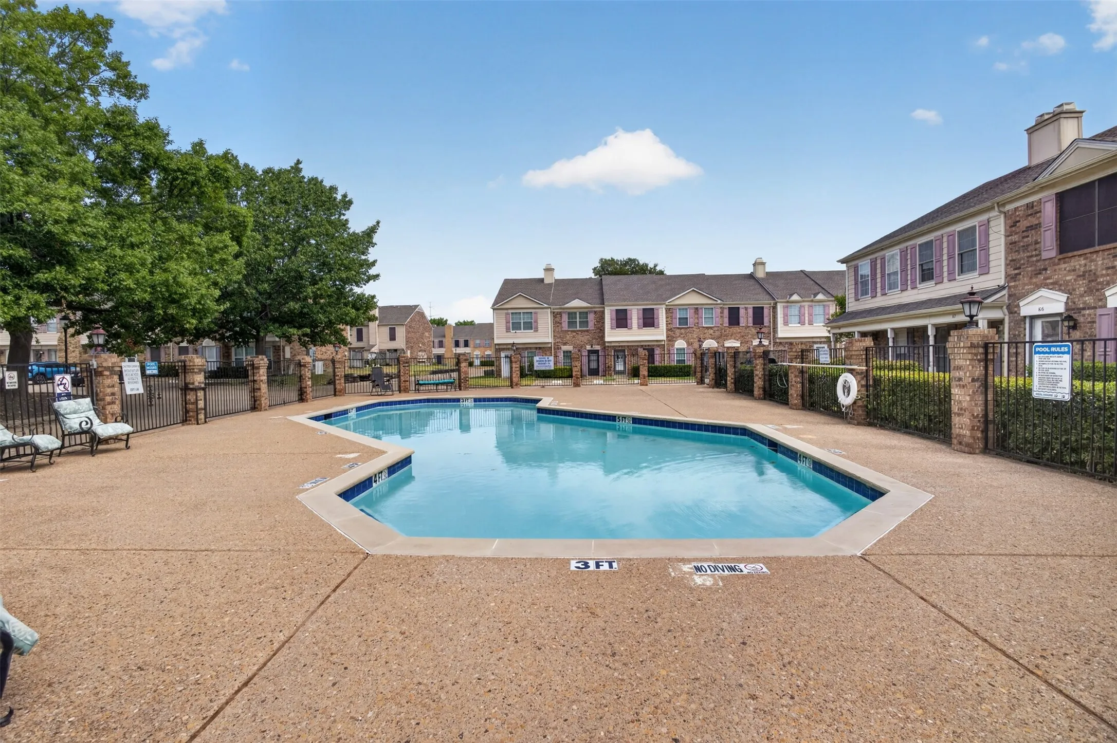 Expansive outdoor pool with a surrounding textured concrete deck