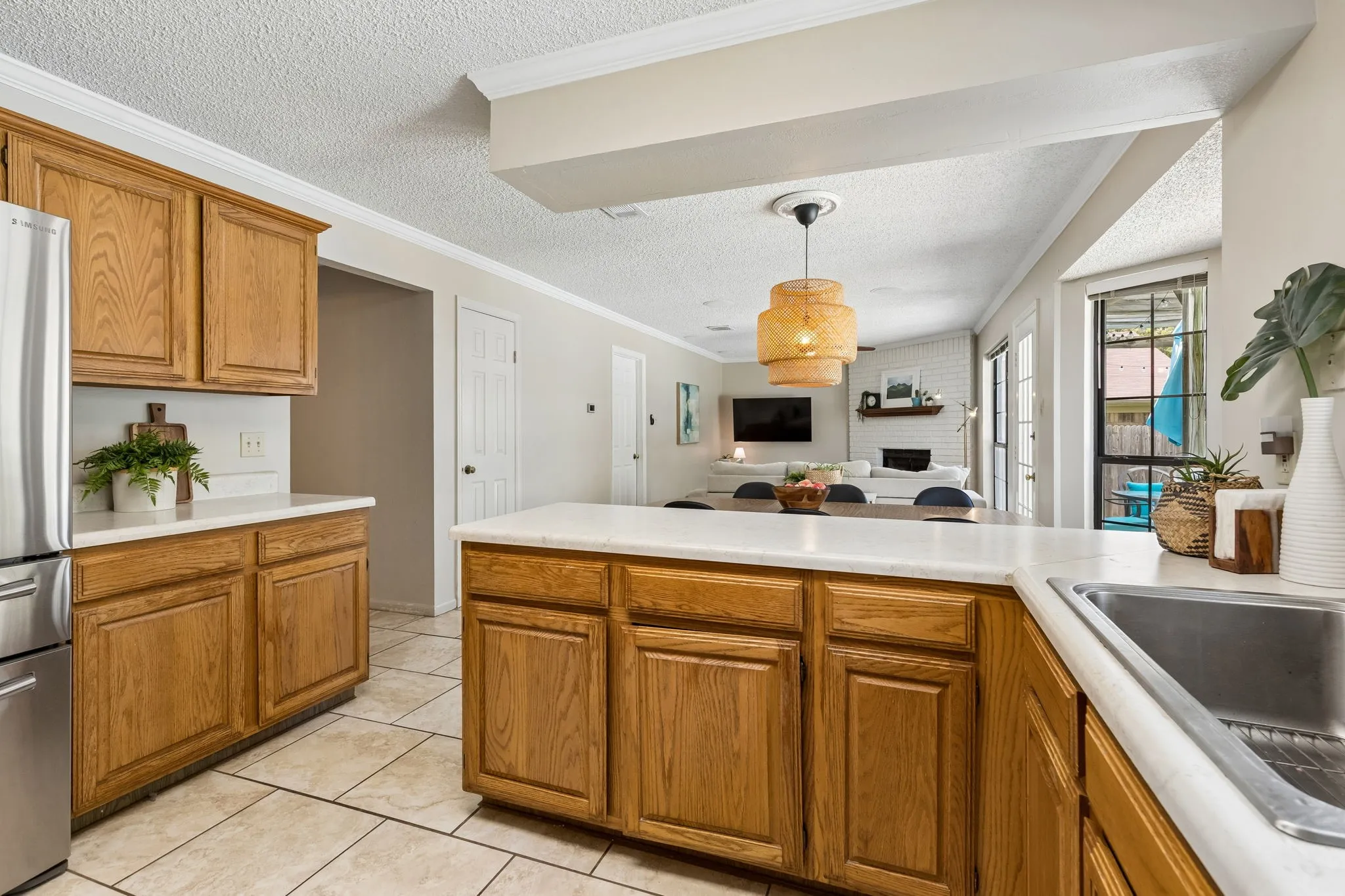 Kitchen with Expansive Breakfast Bar, Abundant Cabinetry and Open Views into the Living Area