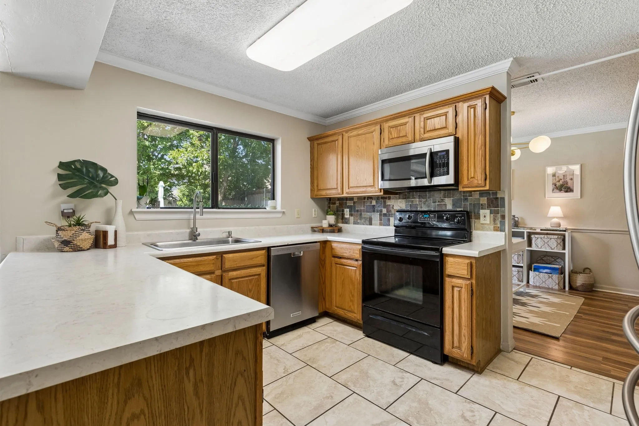 Functional Kitchen with Generous Counter Space, Stainless Steel Dishwasher and Abundant Cabinetry