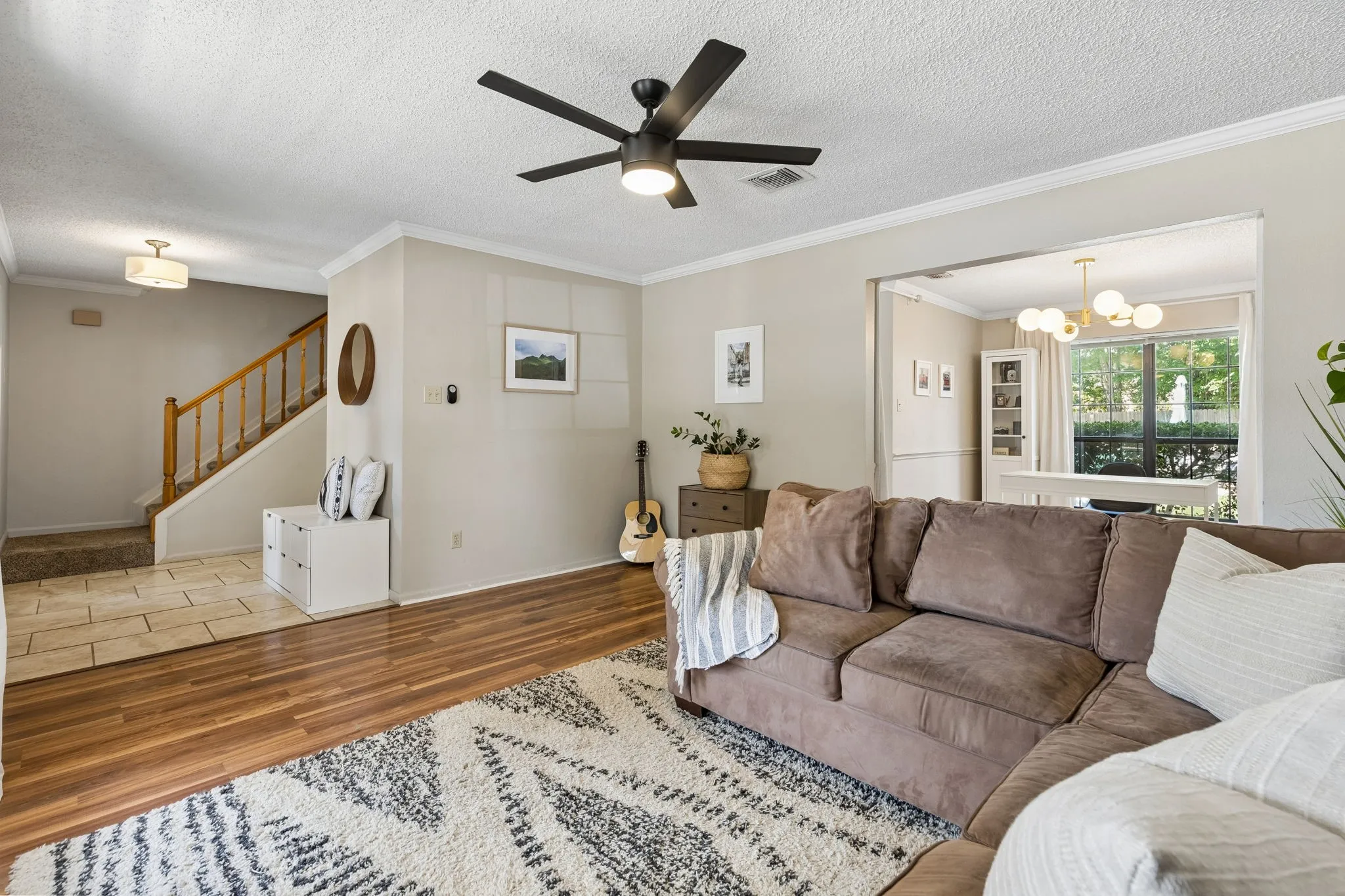 Open Living Area with Modern Ceiling Fan and Easy Flow into the Office