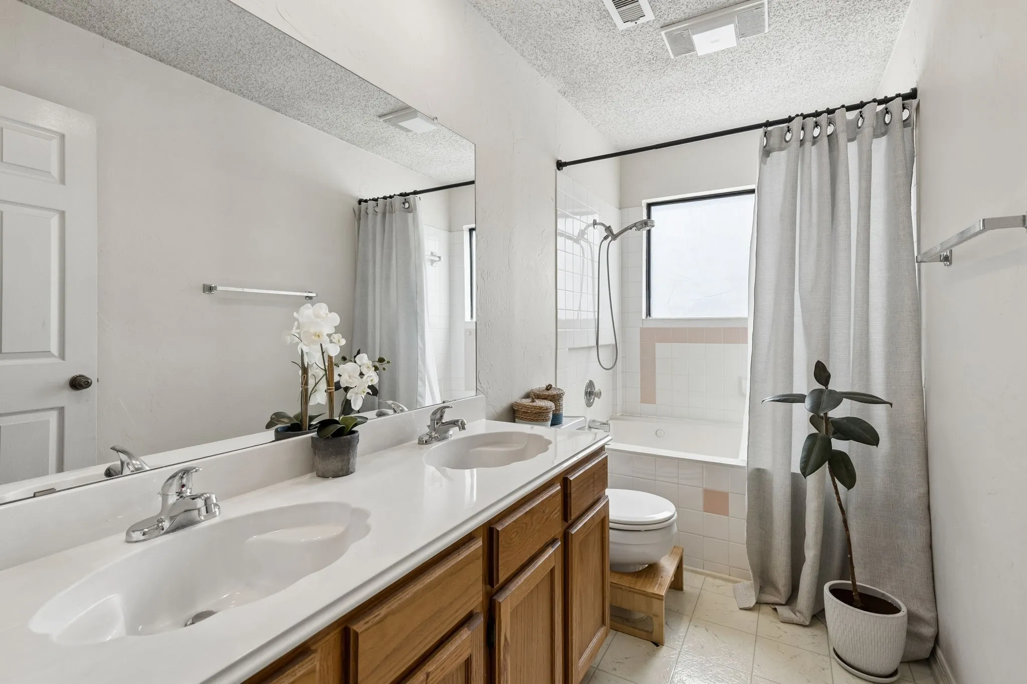 Primary Bath with Dual Sinks, Generous Counter Space and Tile Tub-Shower Combination