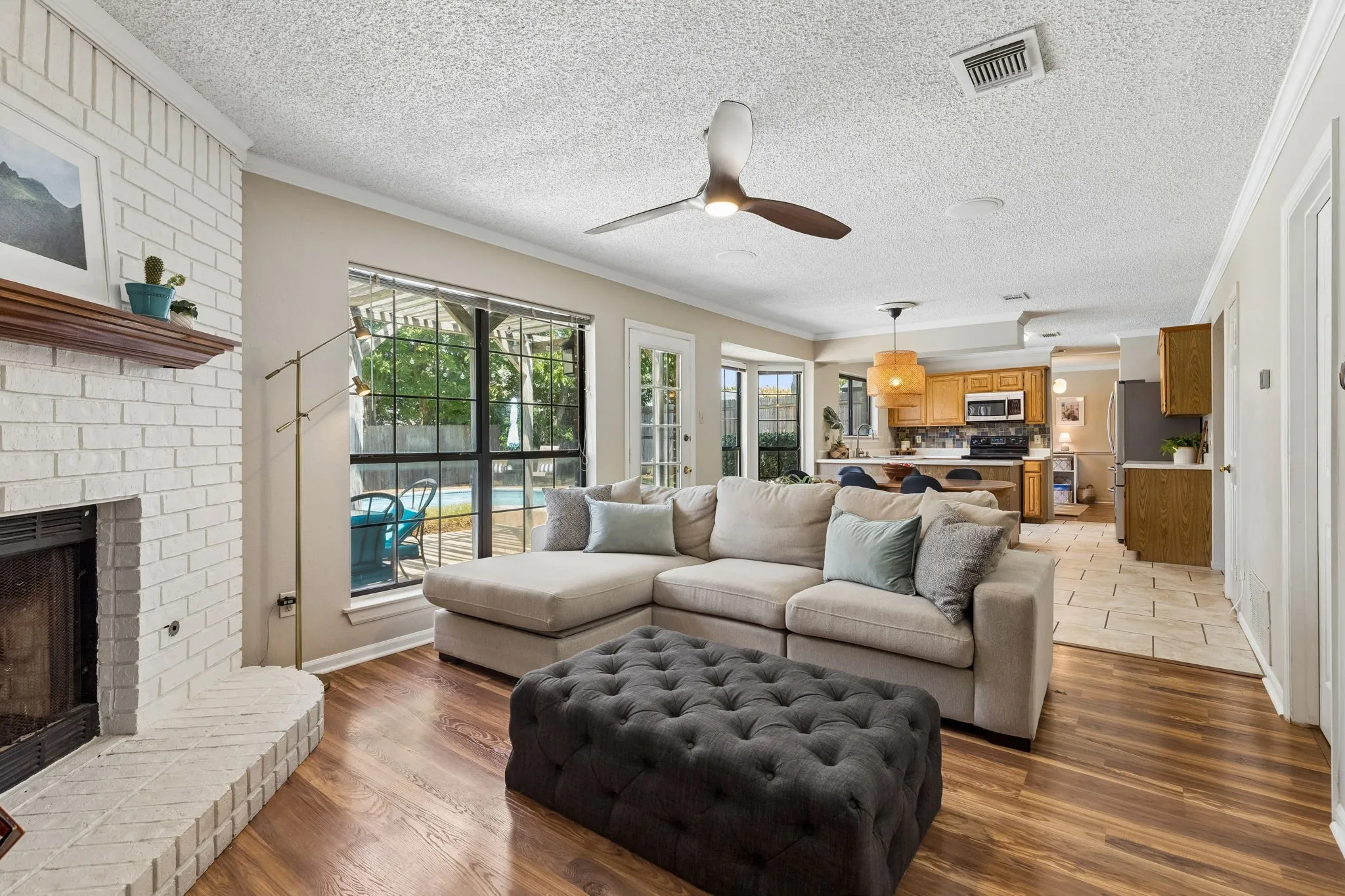Comfortable Living Room with Wood-Look Flooring and Open Sightlines to the Dining Area