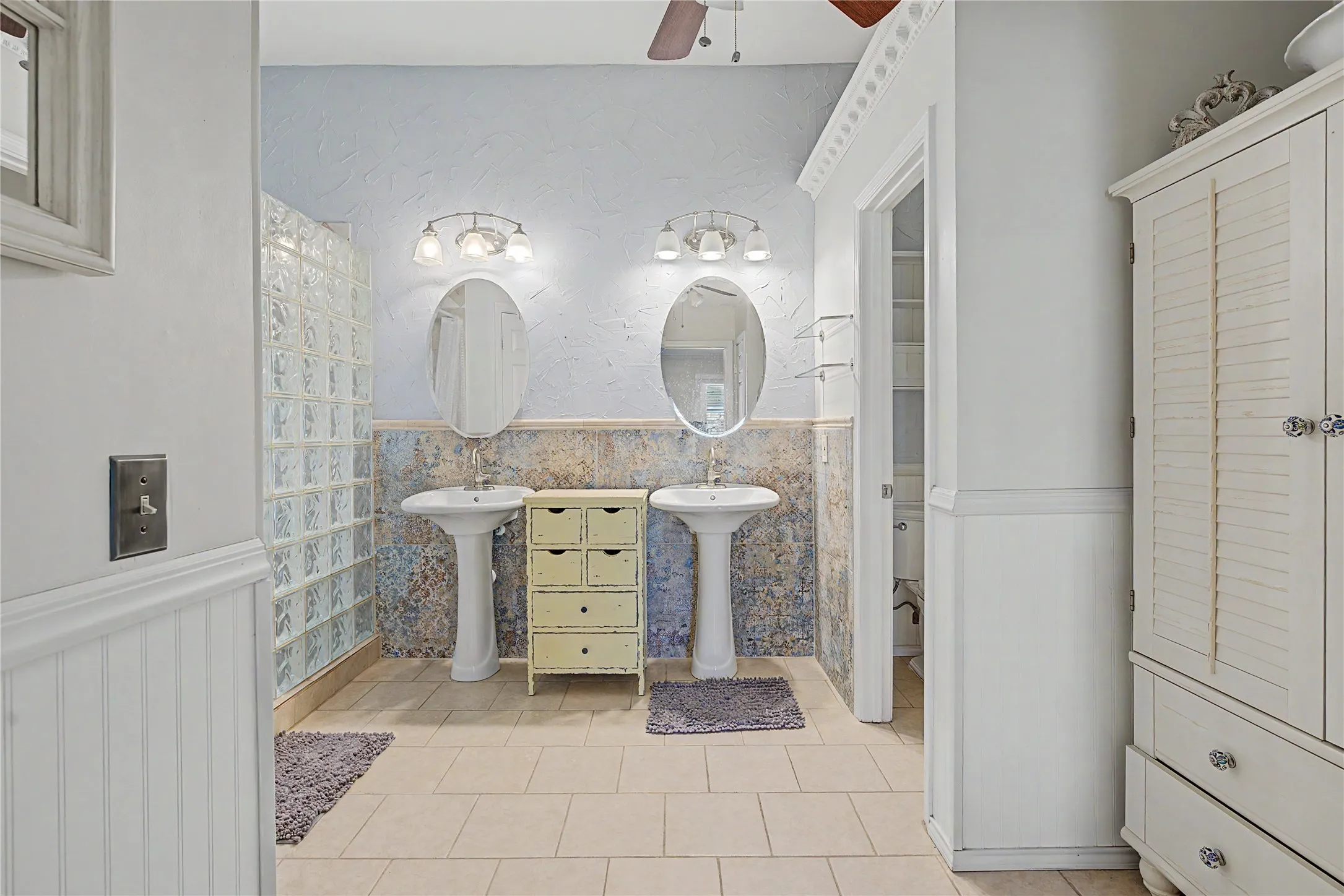Dual pedestal sinks with individual oval mirrors