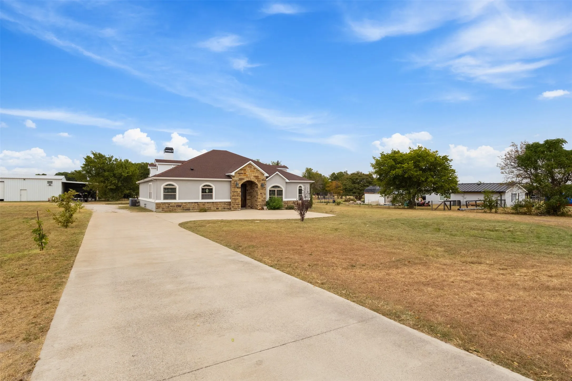 Stucco and stone exterior with arched windows