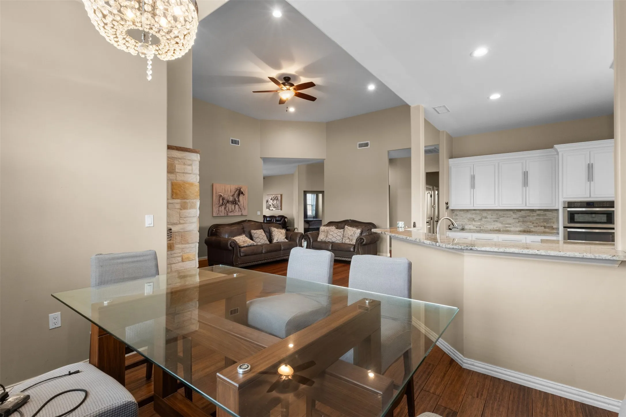 Vaulted ceilings, recessed lighting, and wood-finish flooring