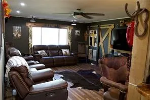 Wood-finish flooring, recessed lighting, and a ceiling fan