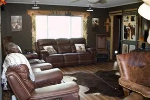 Wood-finish flooring throughout, complemented by a wide window opening with wood trim