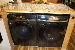 Integrated front-load washer and dryer pair with a stone-finish countertop