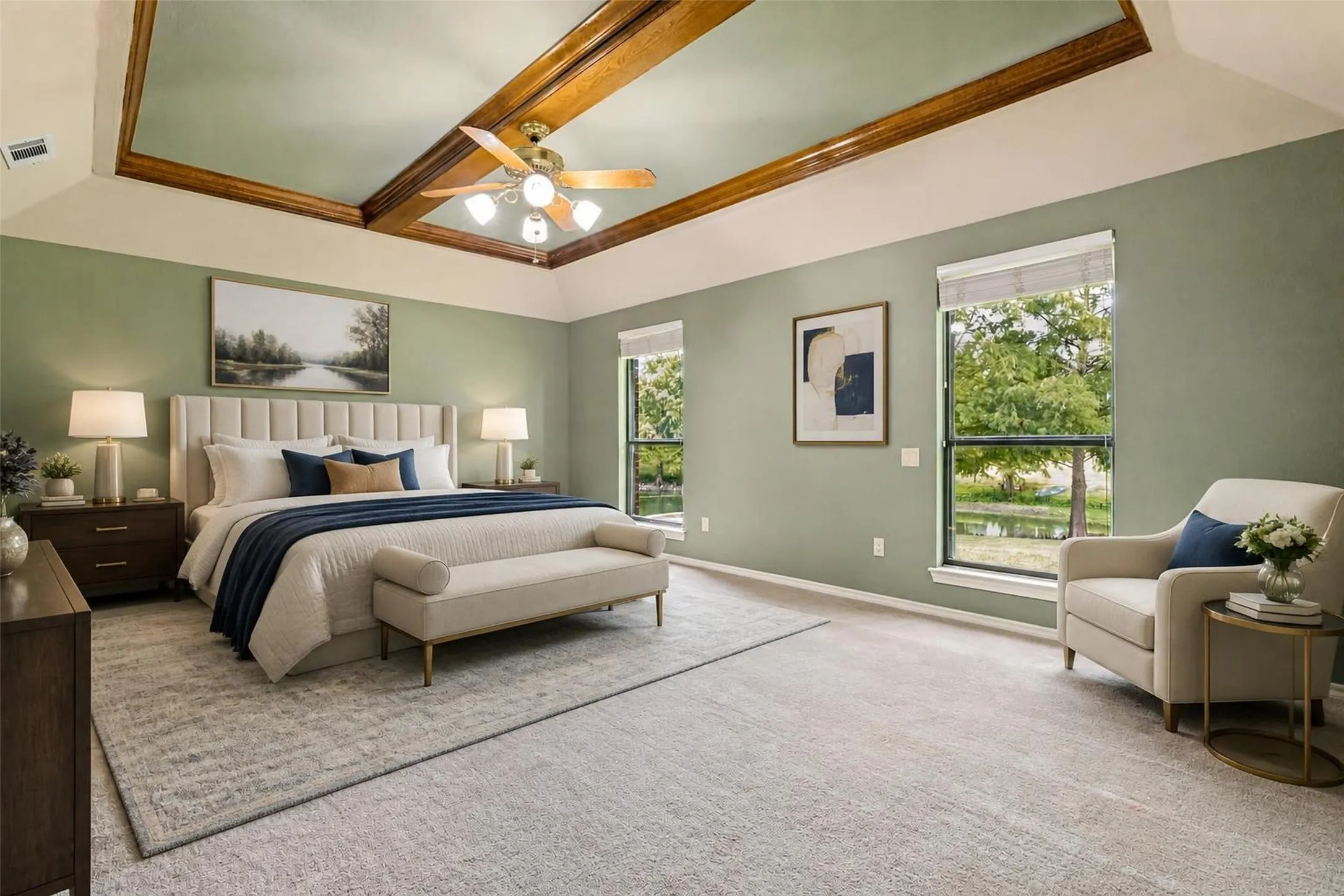 Virtually Staged - Tray ceiling with wood-finish trim, ceiling fan with integrated lighting, two large windows, and wall-to-wall carpeting
