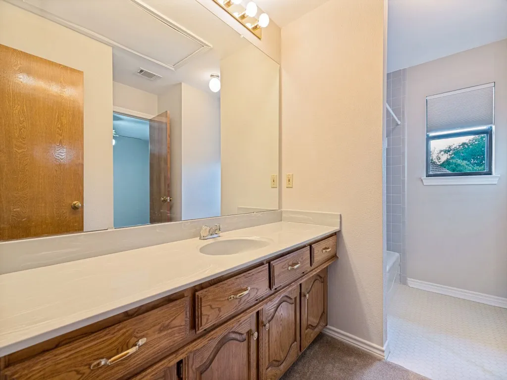 Upstairs bath, with vanity and tub.