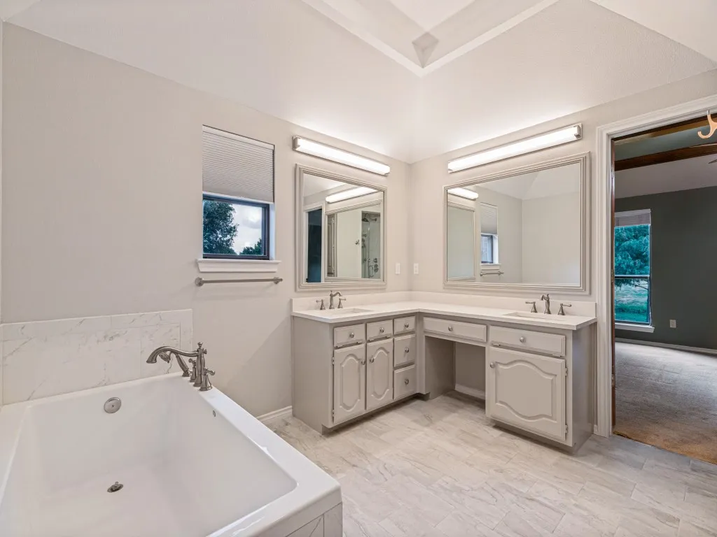 Garden tub, dual vanities with quartz counters.