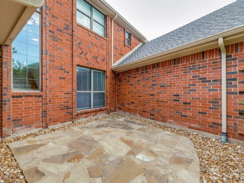 Flagstone patio to the right of entry