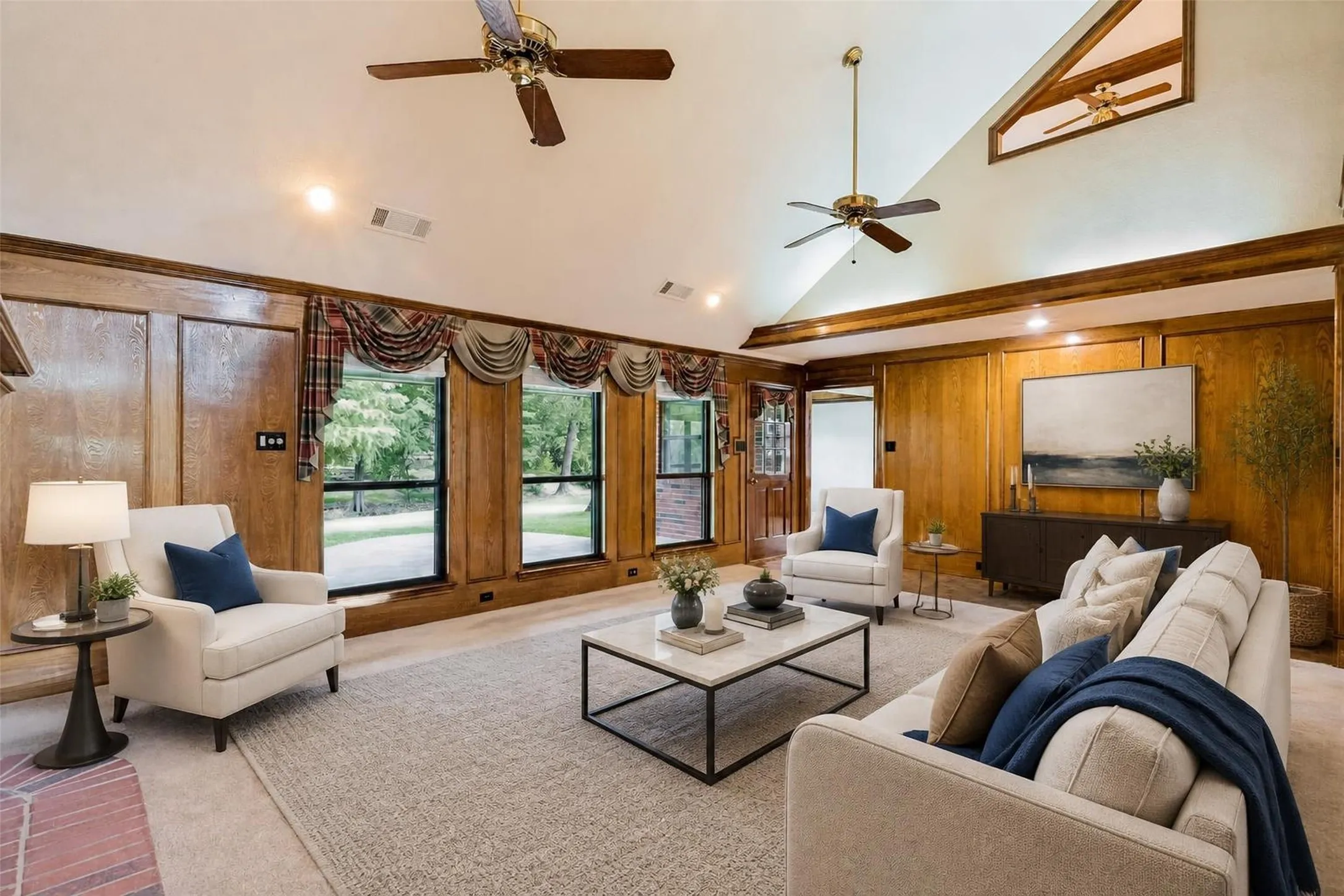 Virtually Staged - Vaulted ceiling with exposed wood beams, ceiling fans, wood paneling, recessed lighting, and large windows