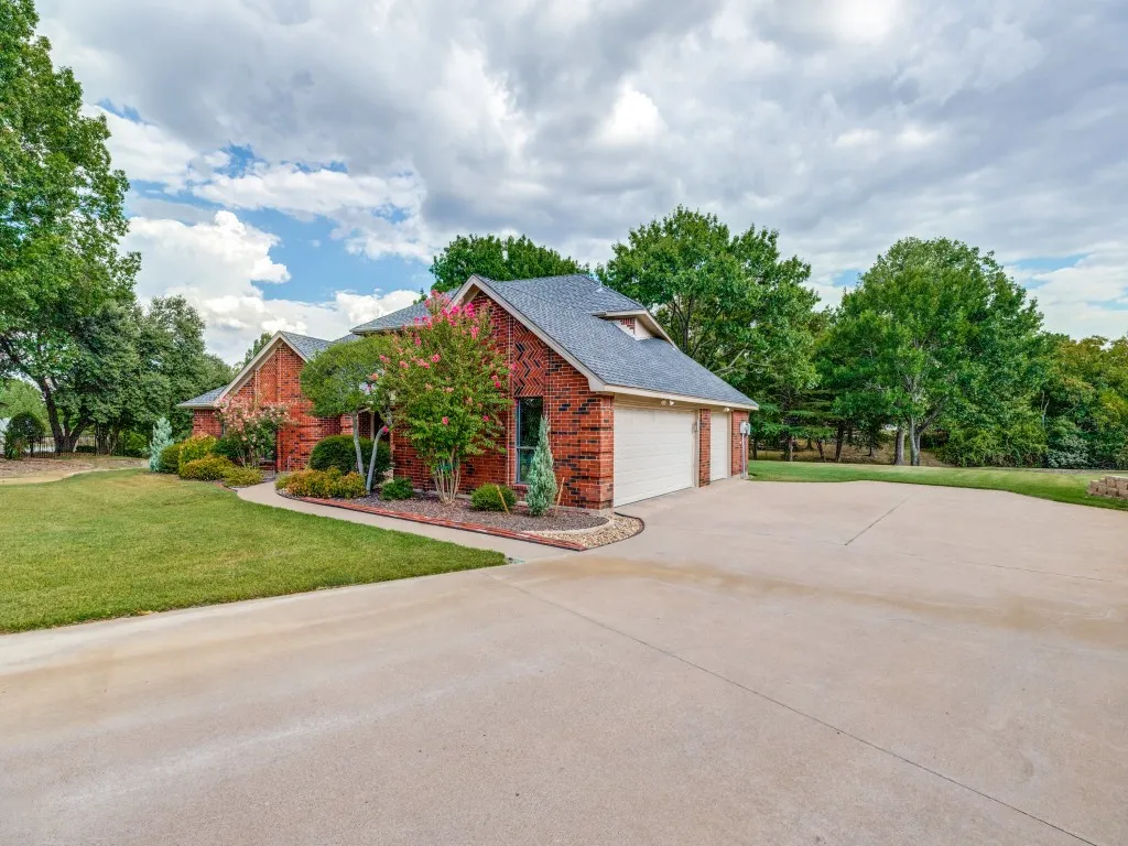 Brick exterior with a gabled roof and 3 car garage