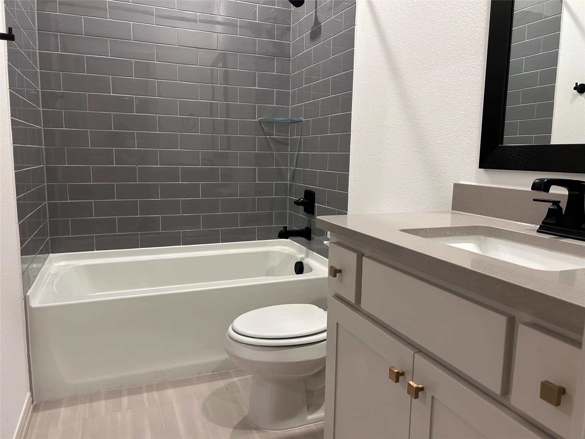 White vanity with integrated sink and stone-finish countertop