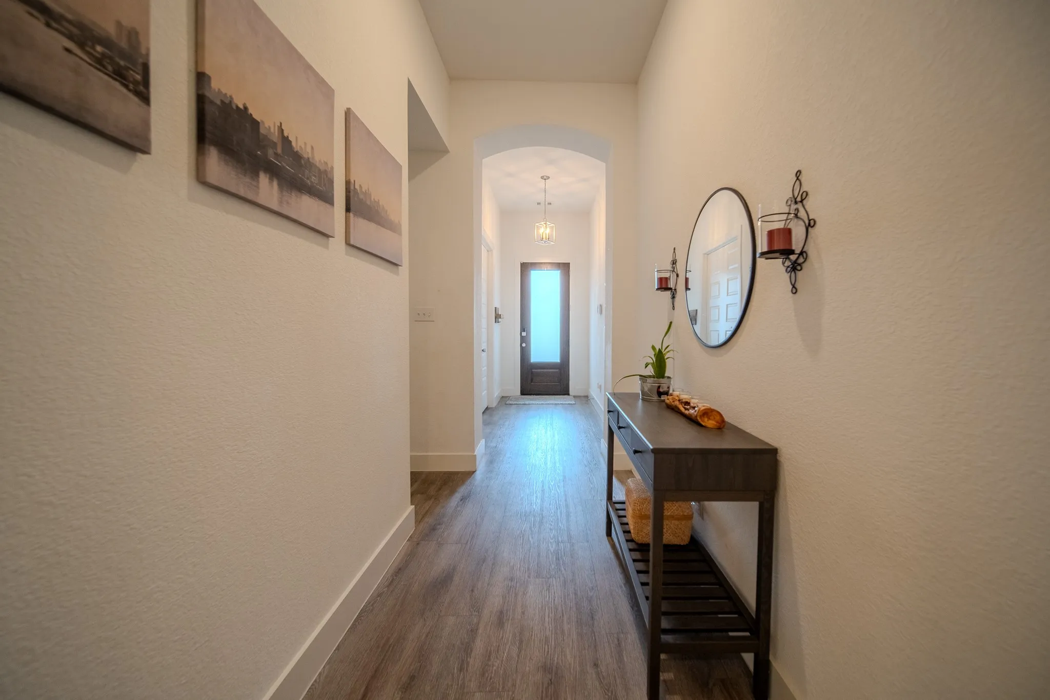 Archway entry with wood-finish flooring