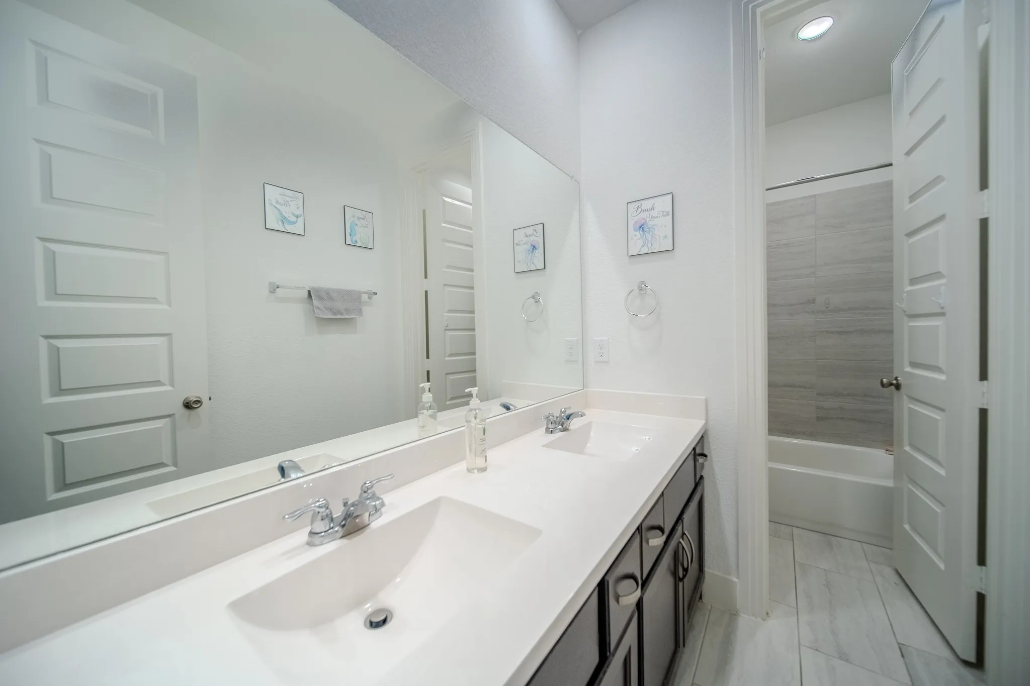 Dual vanity with chrome fixtures and integrated sinks