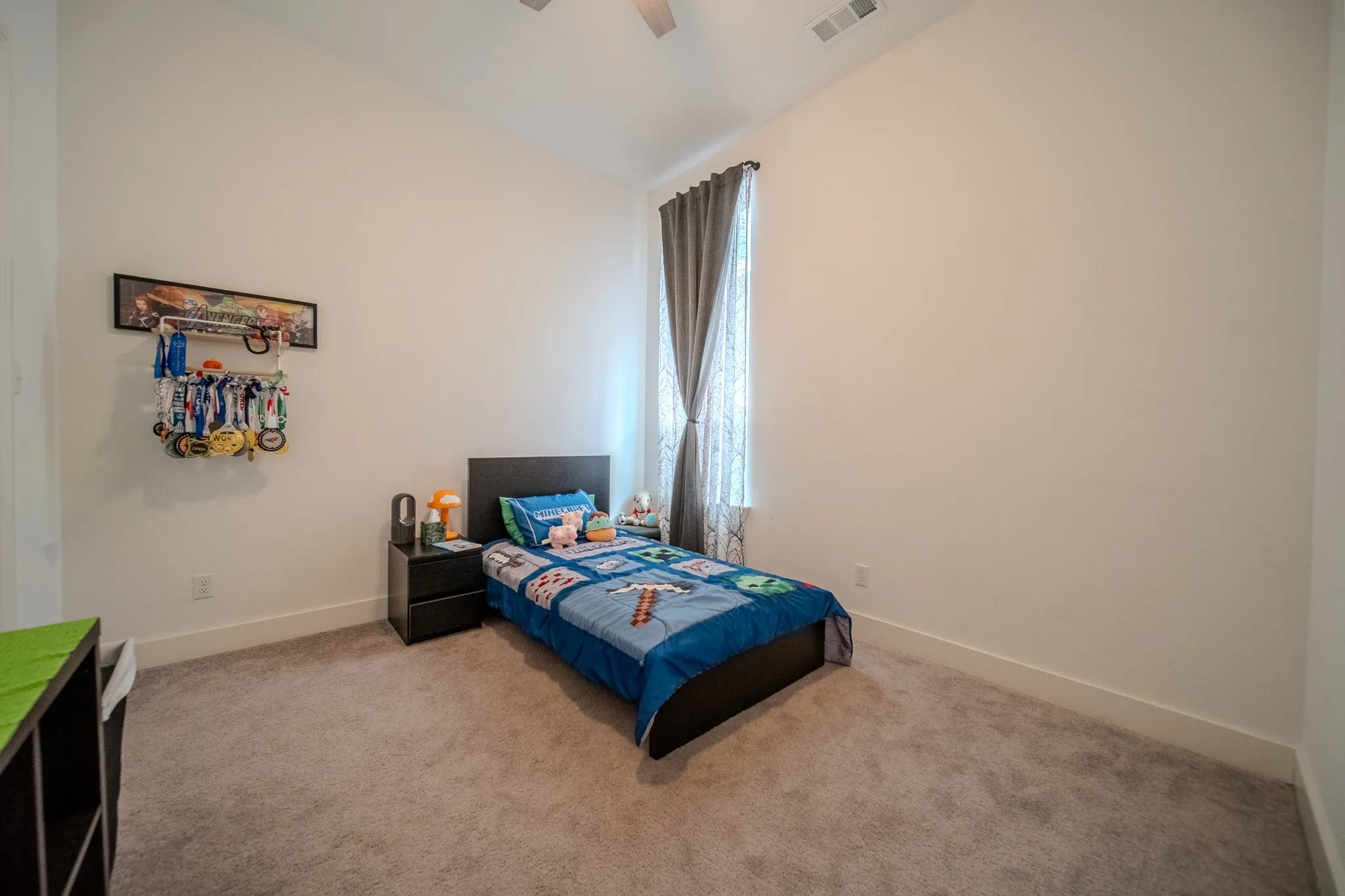 High ceilings with a ceiling fan, carpet flooring, and window with drapes
