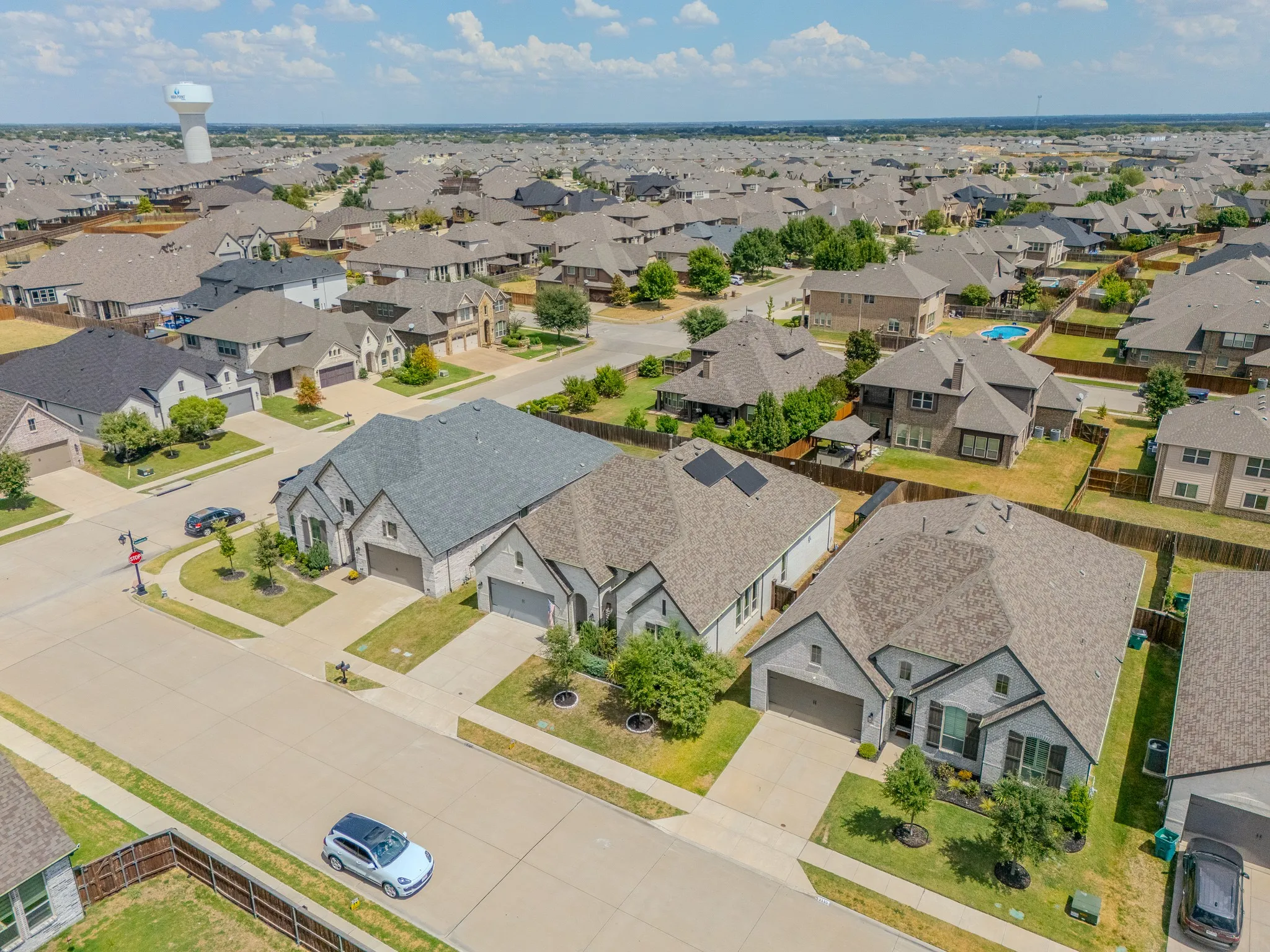 Residential neighborhood featuring single-family homes with pitched roofs and attached garages