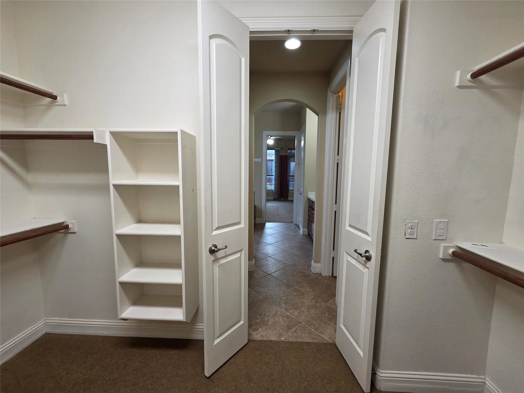 Built-in shelving, hanging rods, and carpeting
