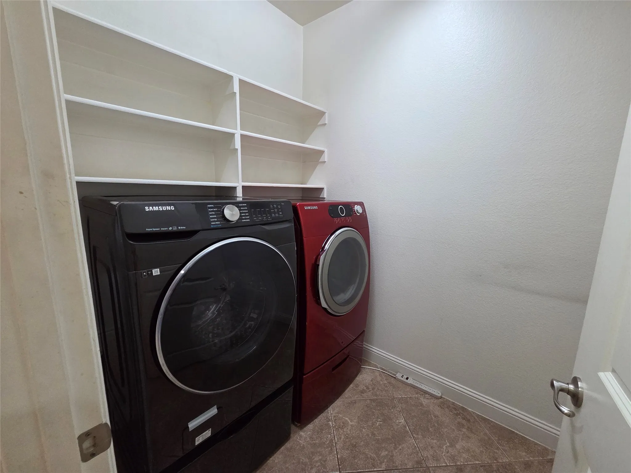 Built-in shelving for storage, neutral wall paint, and tile flooring