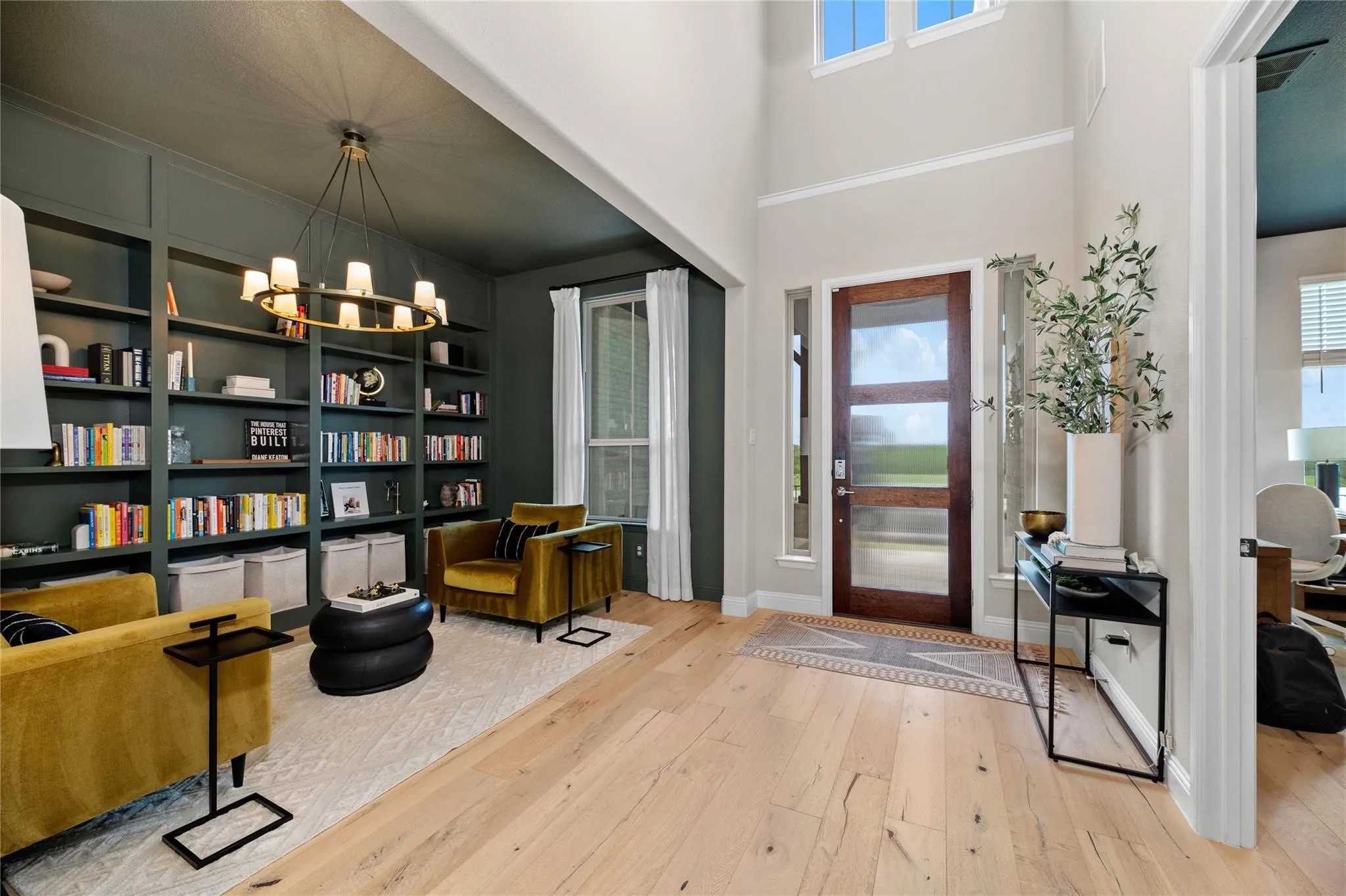 Double-height entry with a wood-panel door and transom window