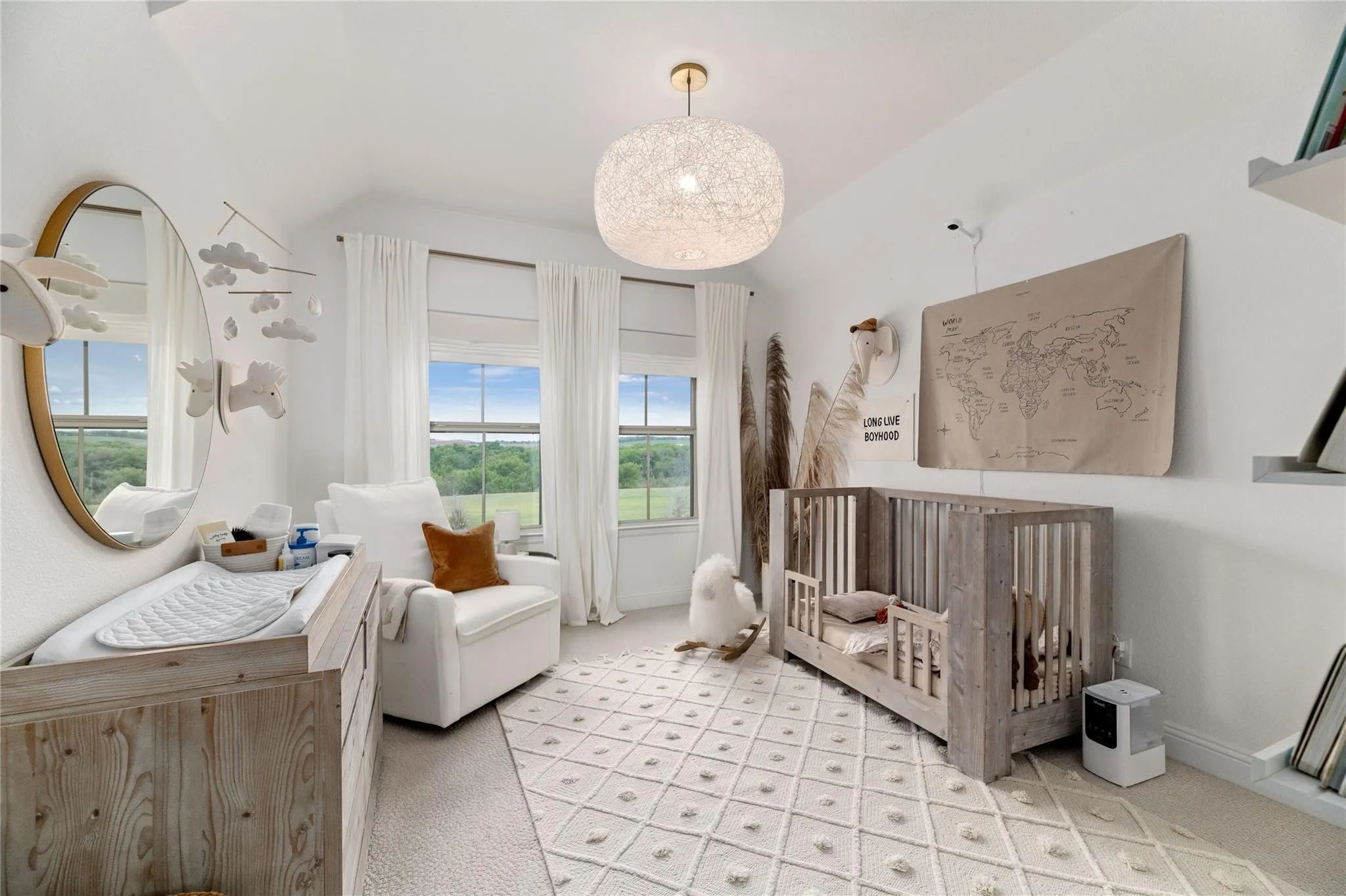 White walls with vaulted ceilings, featuring two windows with white shades