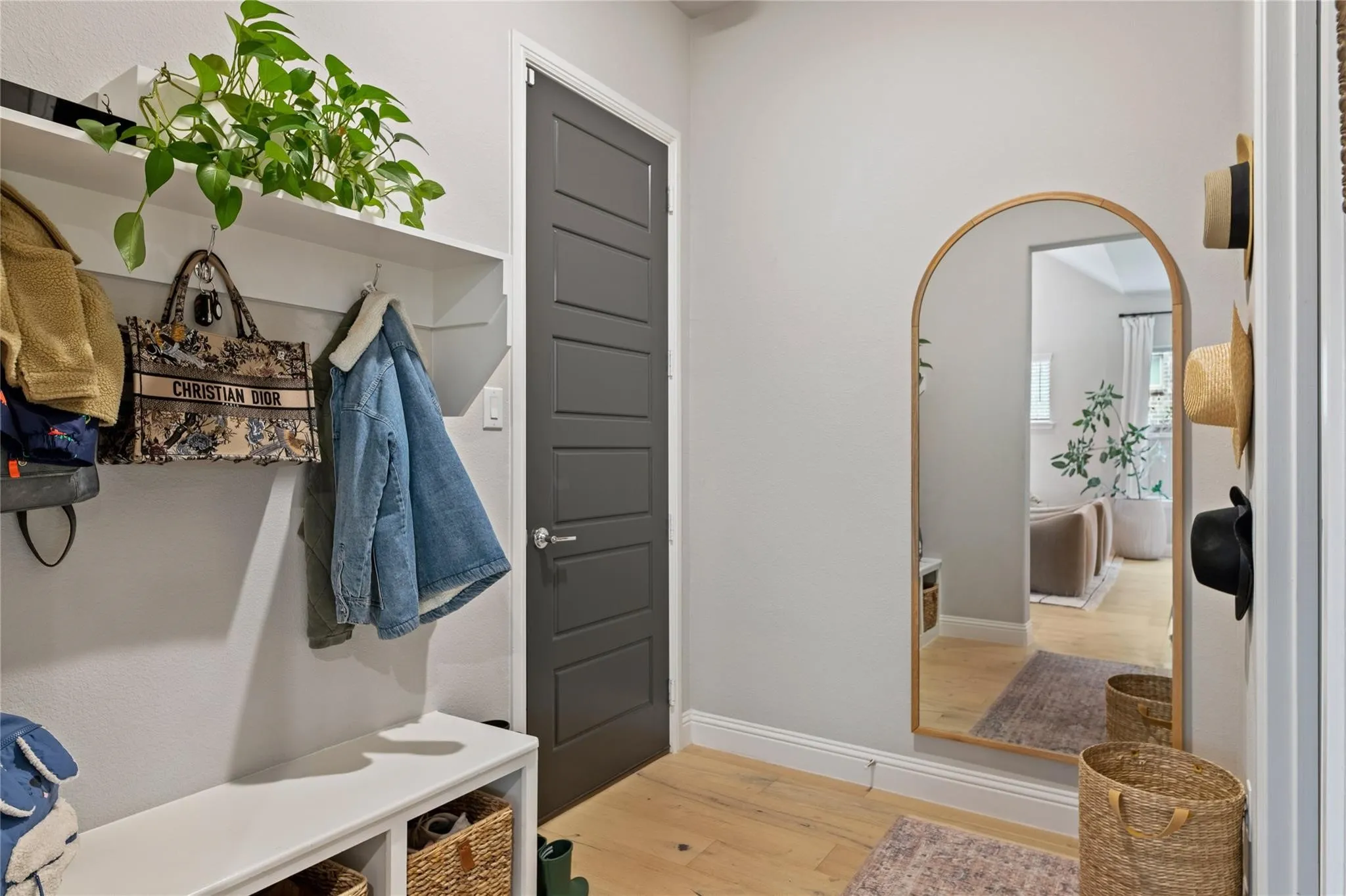 White wood-finish flooring with a built-in storage bench