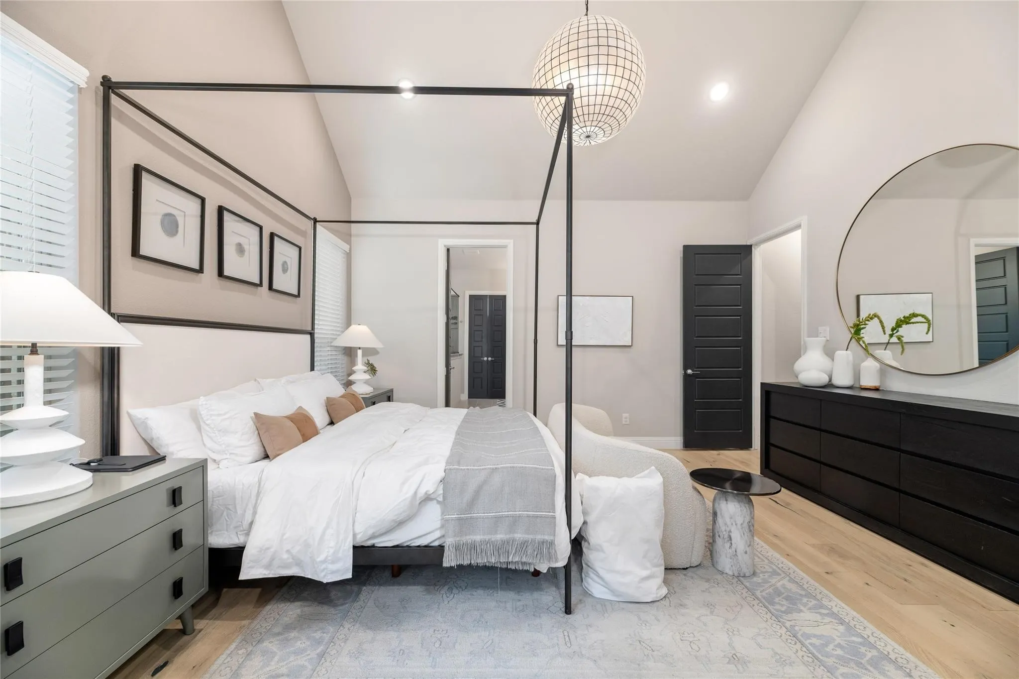 Vaulted ceiling, recessed lighting, wood-finish flooring, two-panel interior doors, and a decorative pendant light fixture