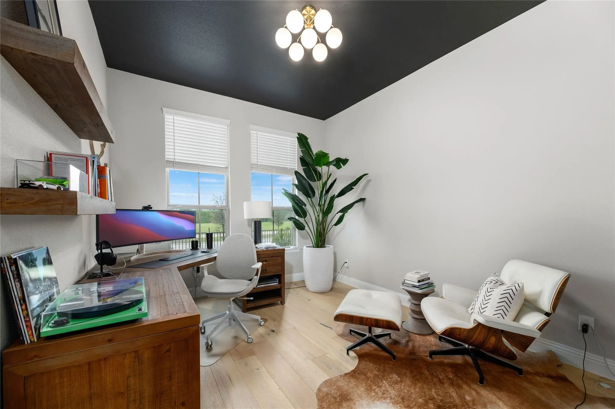 Black accent ceiling with a contemporary flush mount light fixture